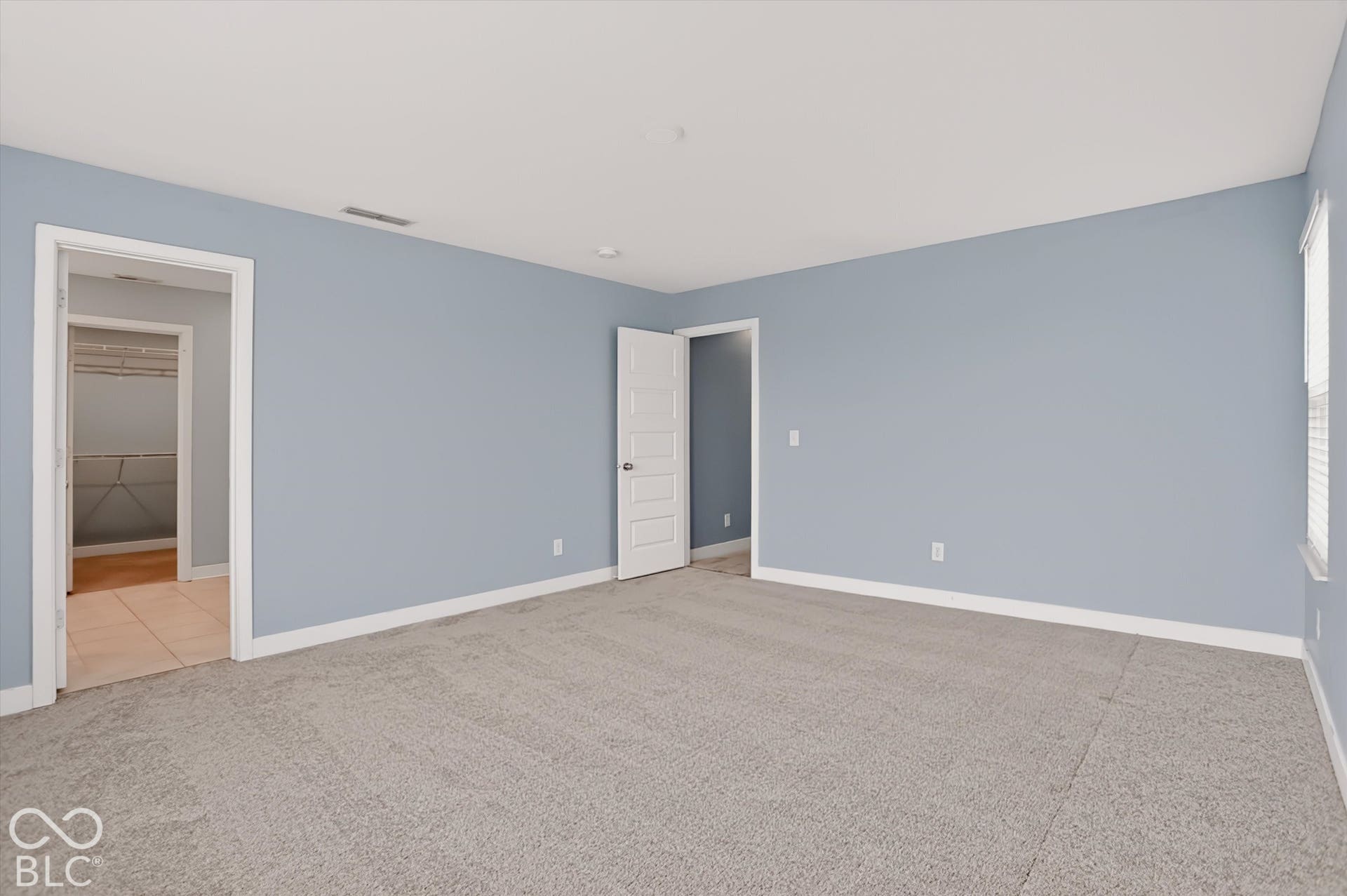 Neutral wall coloring, wall-to-wall carpeting, and multi-panel interior doors