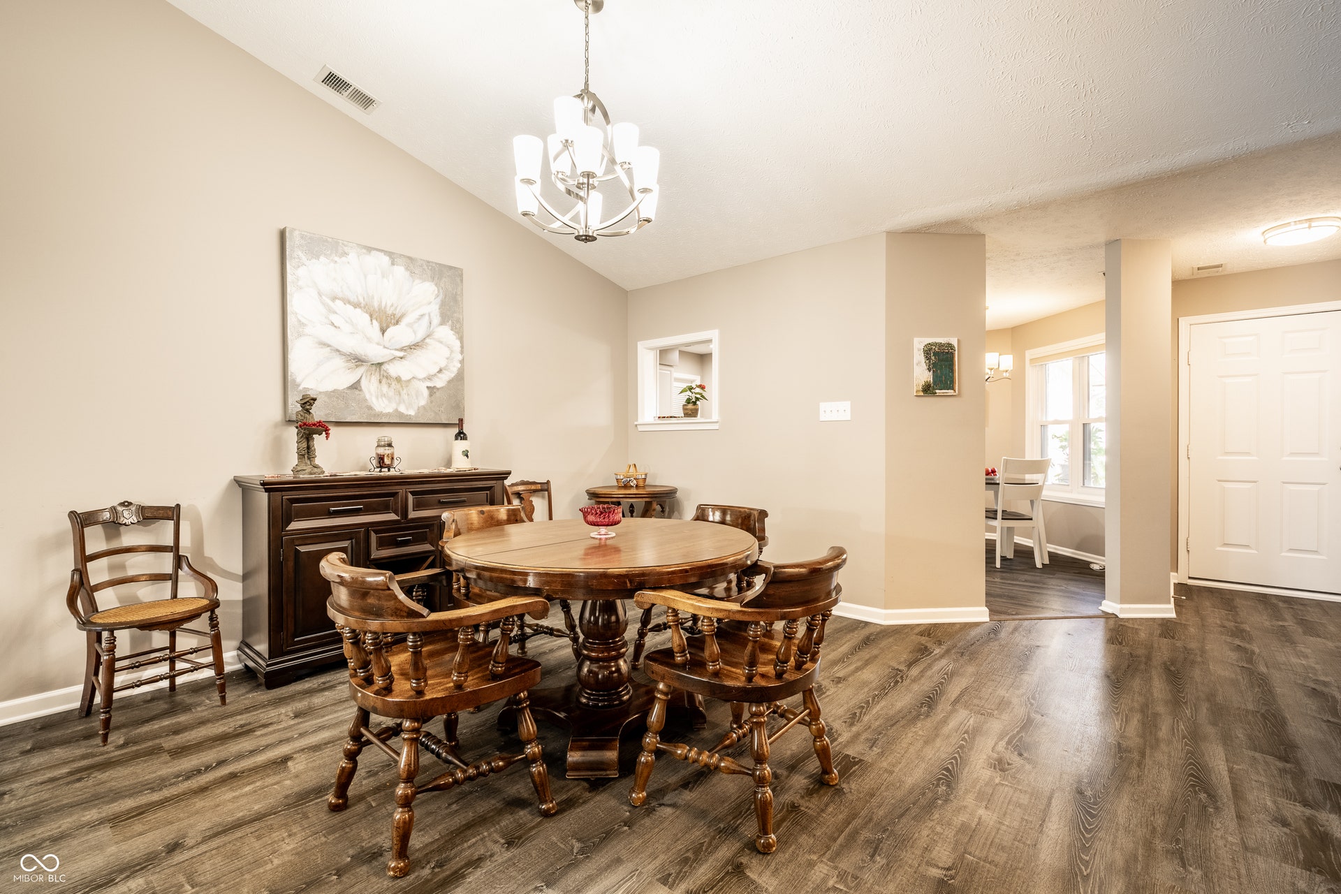 Open concept, vaulted ceiling with an attached chandelier, LVP wood- flooring