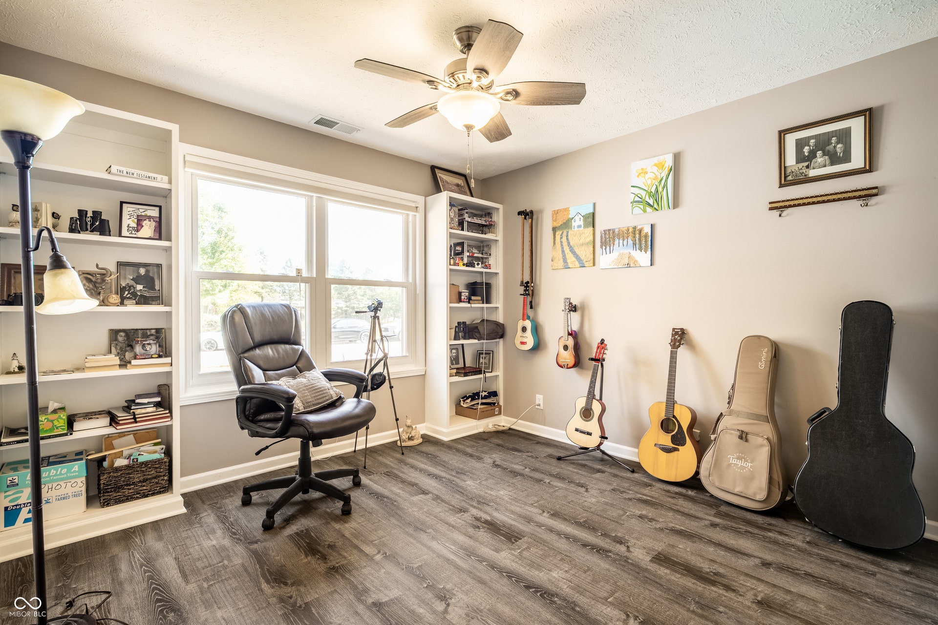 OR Office/Study/Hobby room with LVP flooring, dual built-in shelving units, a large window, Closet and a ceiling fan with integrated lighting