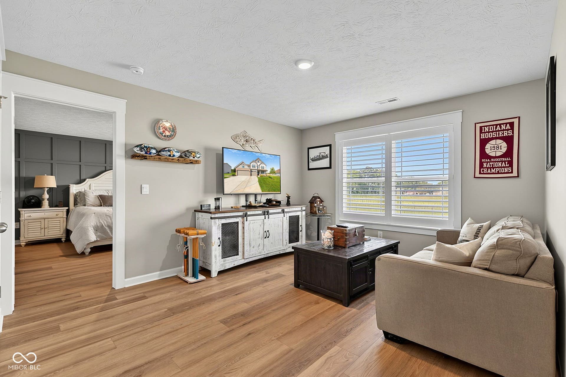 Wood-finish flooring throughout, recessed lighting, and white window blinds
