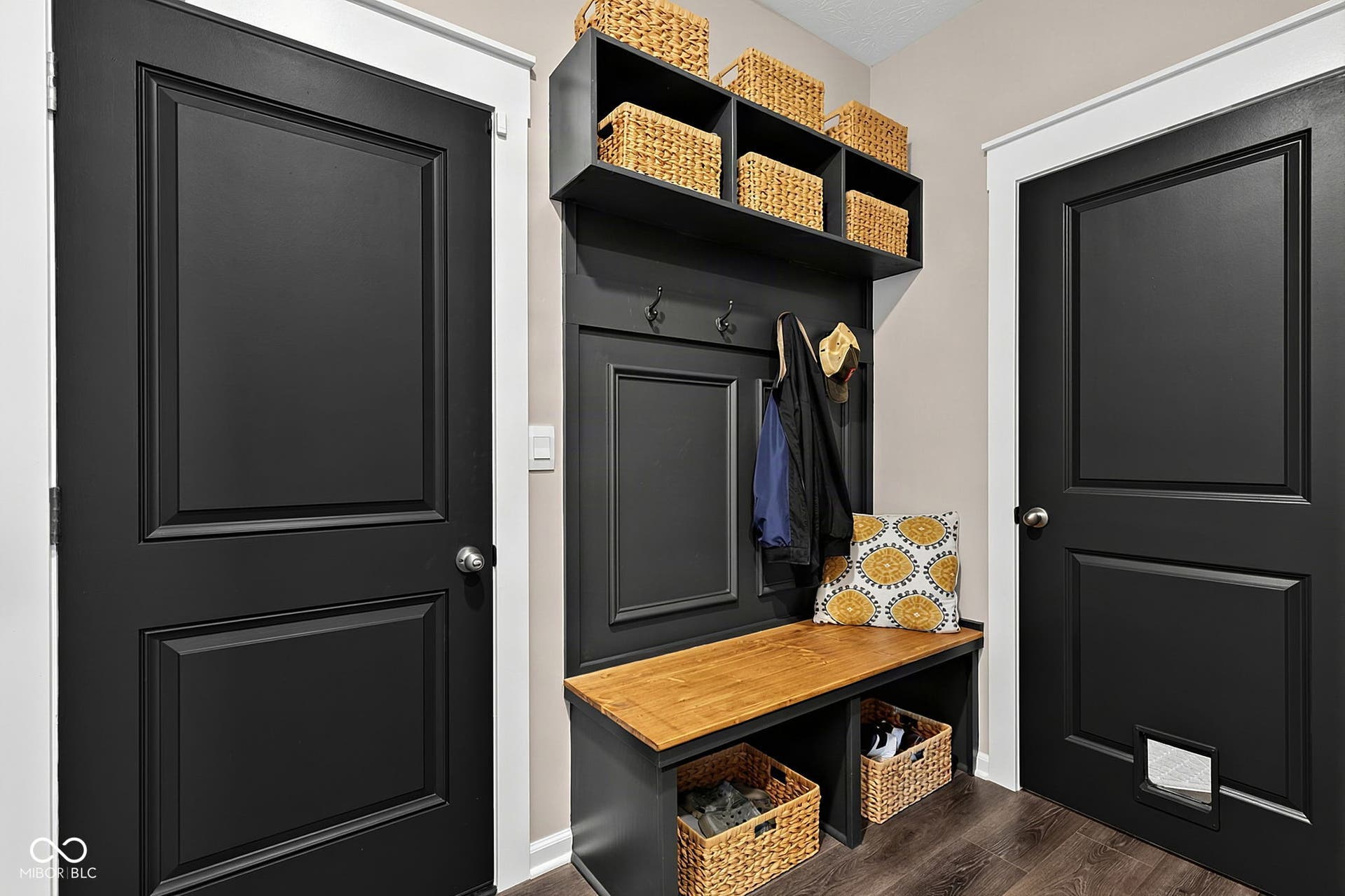 Built-in mudroom bench with wood-finish top, integrated shelving, and wall hooks