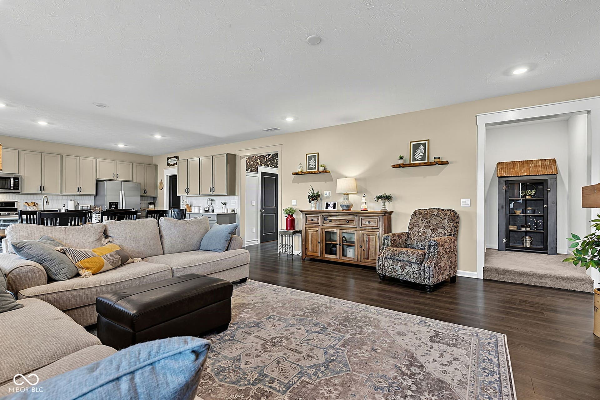 Recessed lighting, wood-finish flooring, light-toned walls, built-in cabinetry, stainless steel appliances