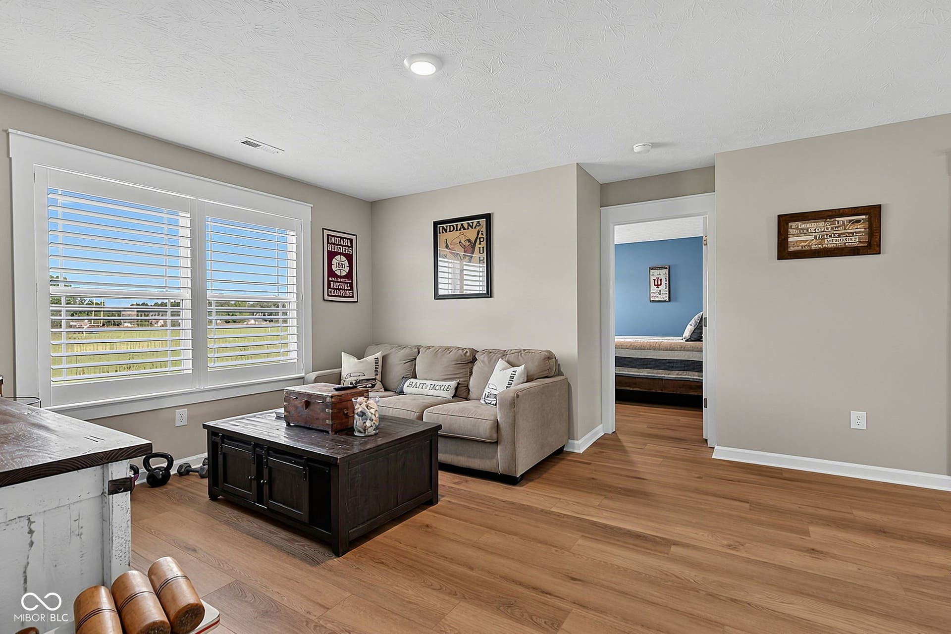 Warm wood-finish flooring complements light neutral walls
