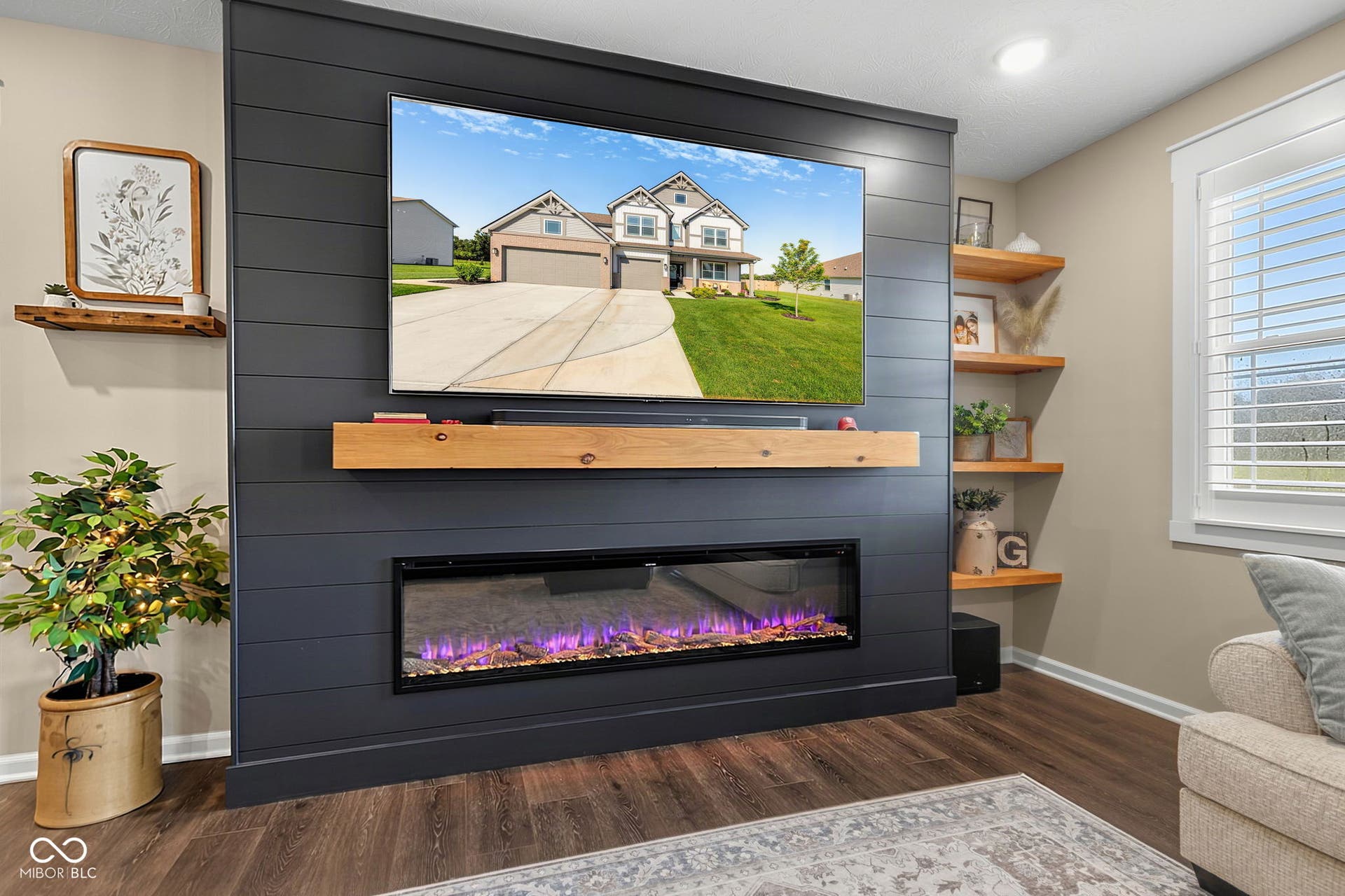 Shiplap accent wall with an integrated electric fireplace, wood-finish flooring, and built-in floating shelves
