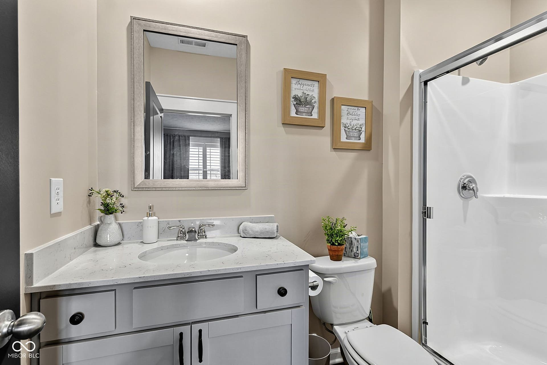 Vanity with an integrated sink, polished chrome faucet, and stone countertop