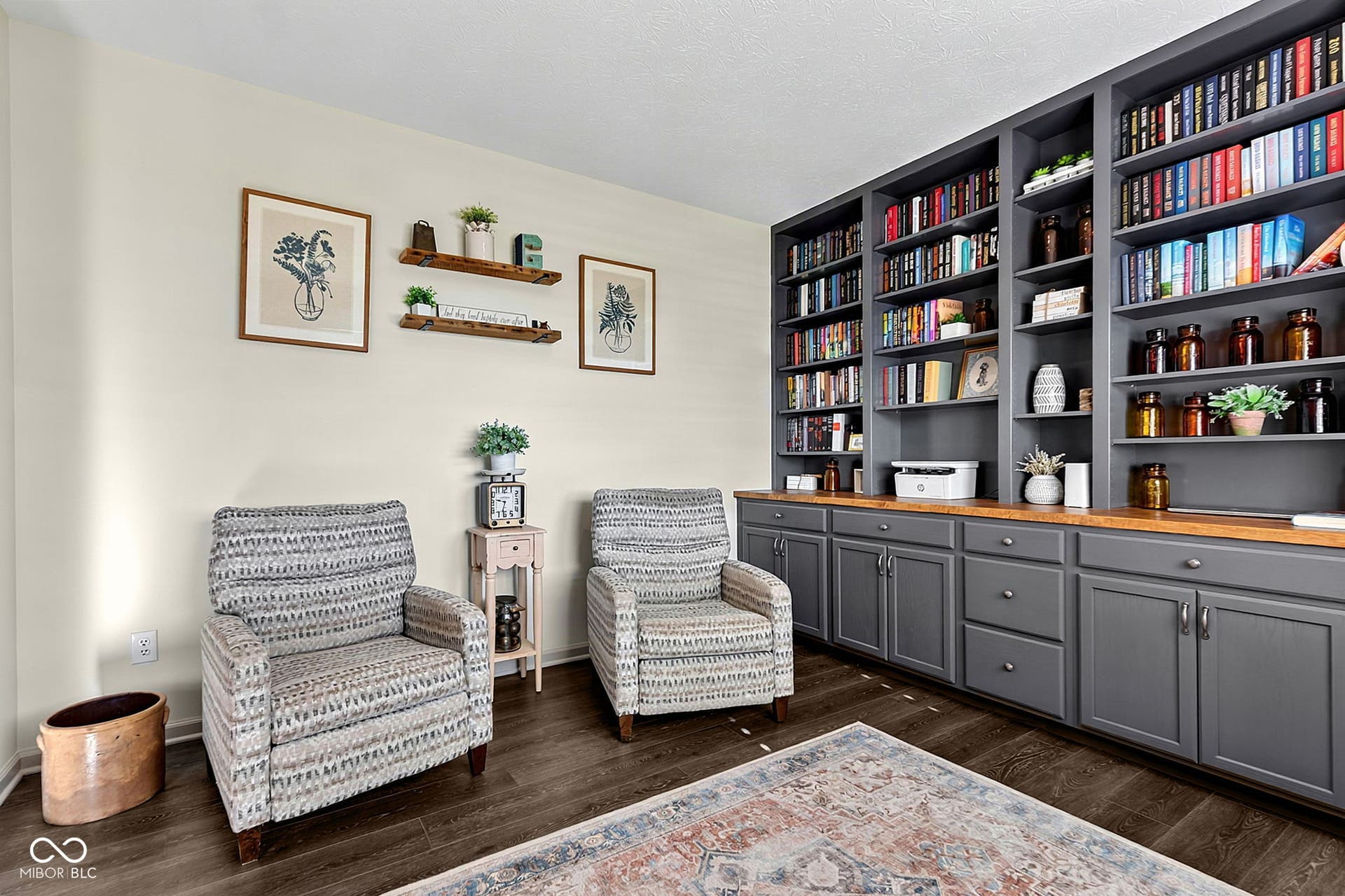 Built-in shelving with integrated cabinetry, wood-finish countertop, and dark wood-finish flooring