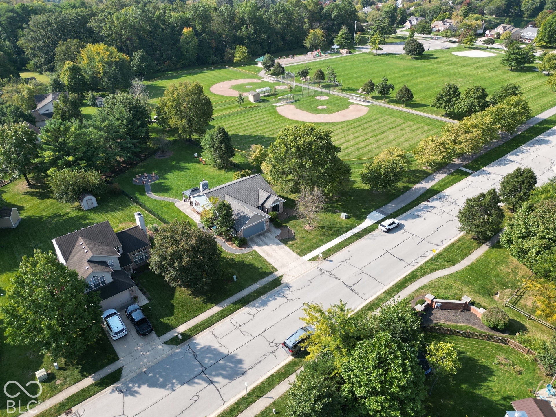 Expansive neighborhood park featuring a baseball diamond and manicured green spaces