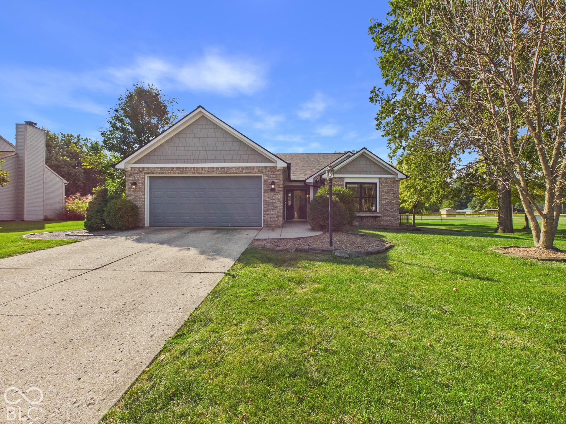 Brick and shingle exterior with an attached two-car garage