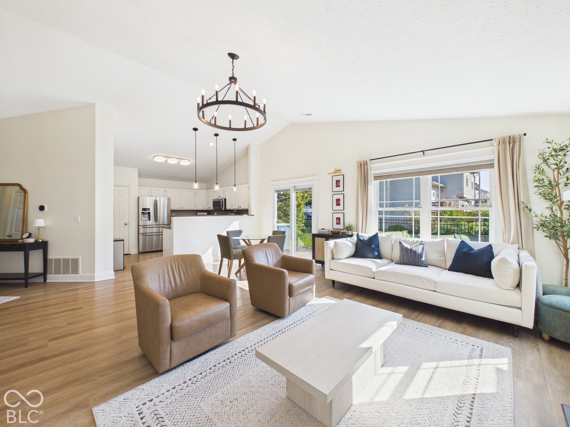 Vaulted ceilings, wood-finish flooring, and a contemporary chandelier