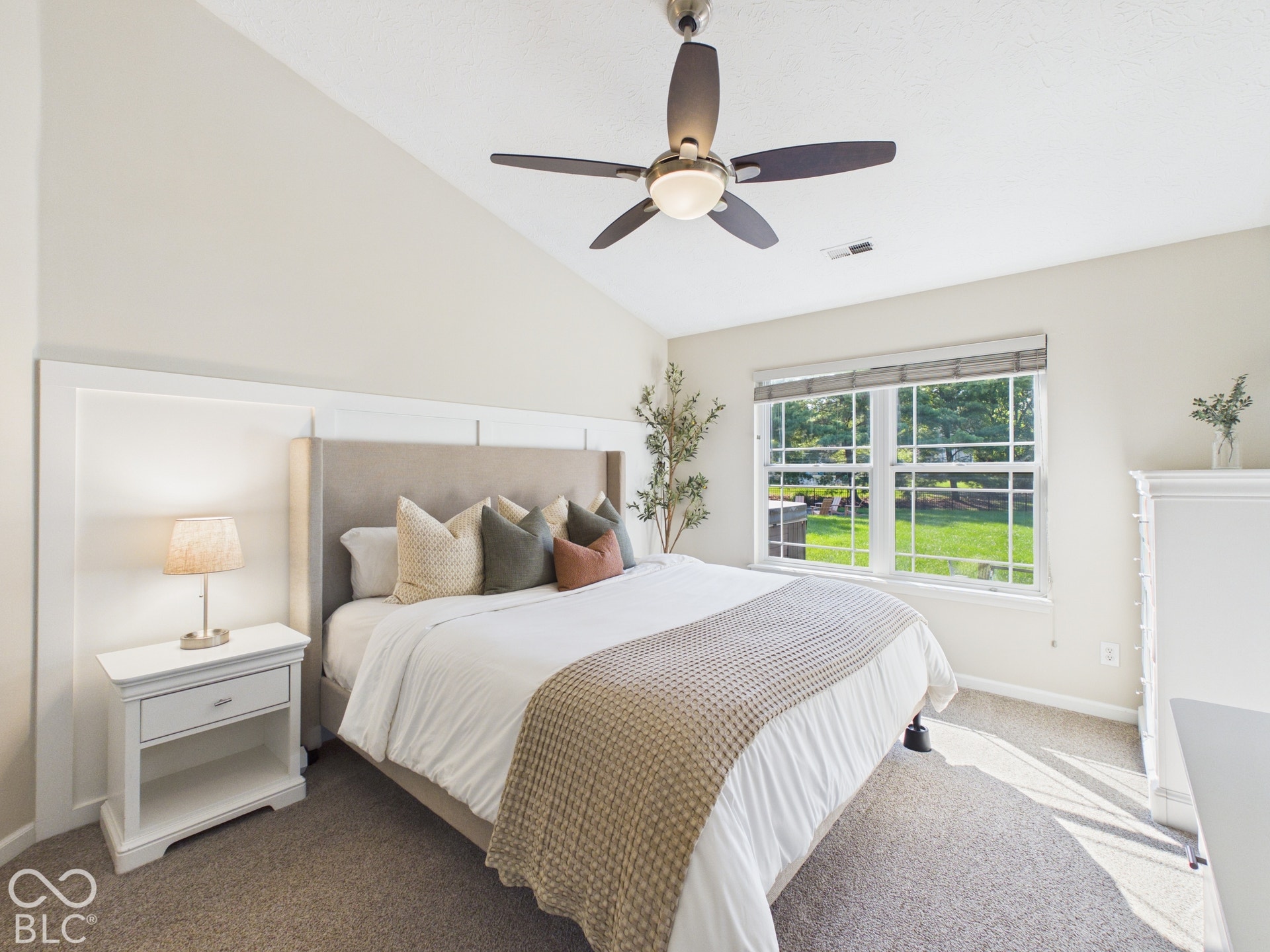 Vaulted ceiling, carpeted flooring, multi-pane window, ceiling fan with integrated lighting, custom wall paneling