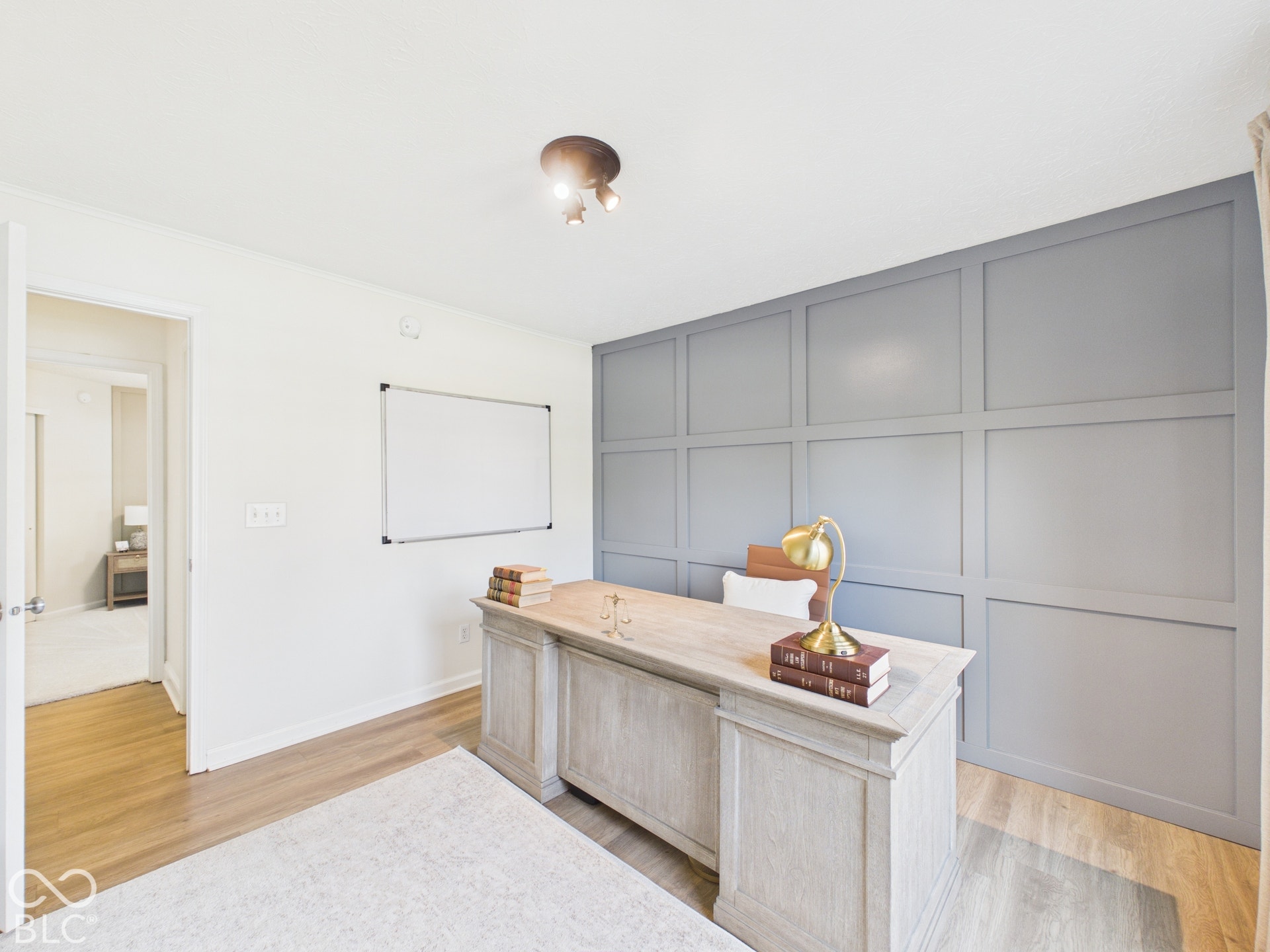 Accent wall featuring wainscoting and a neutral paint finish