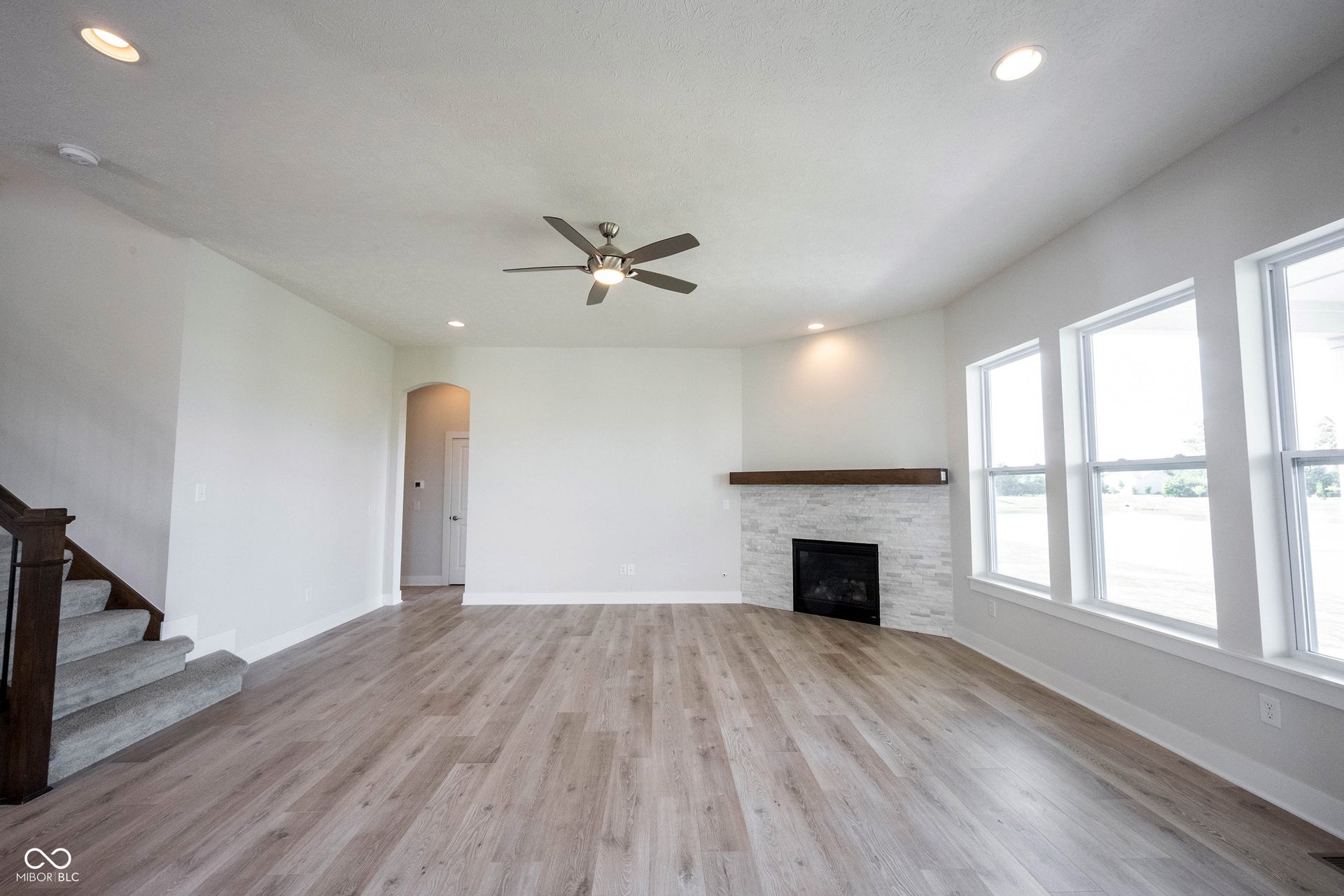 Great room with laminated wood floors, gas fireplace and lots of natural light.