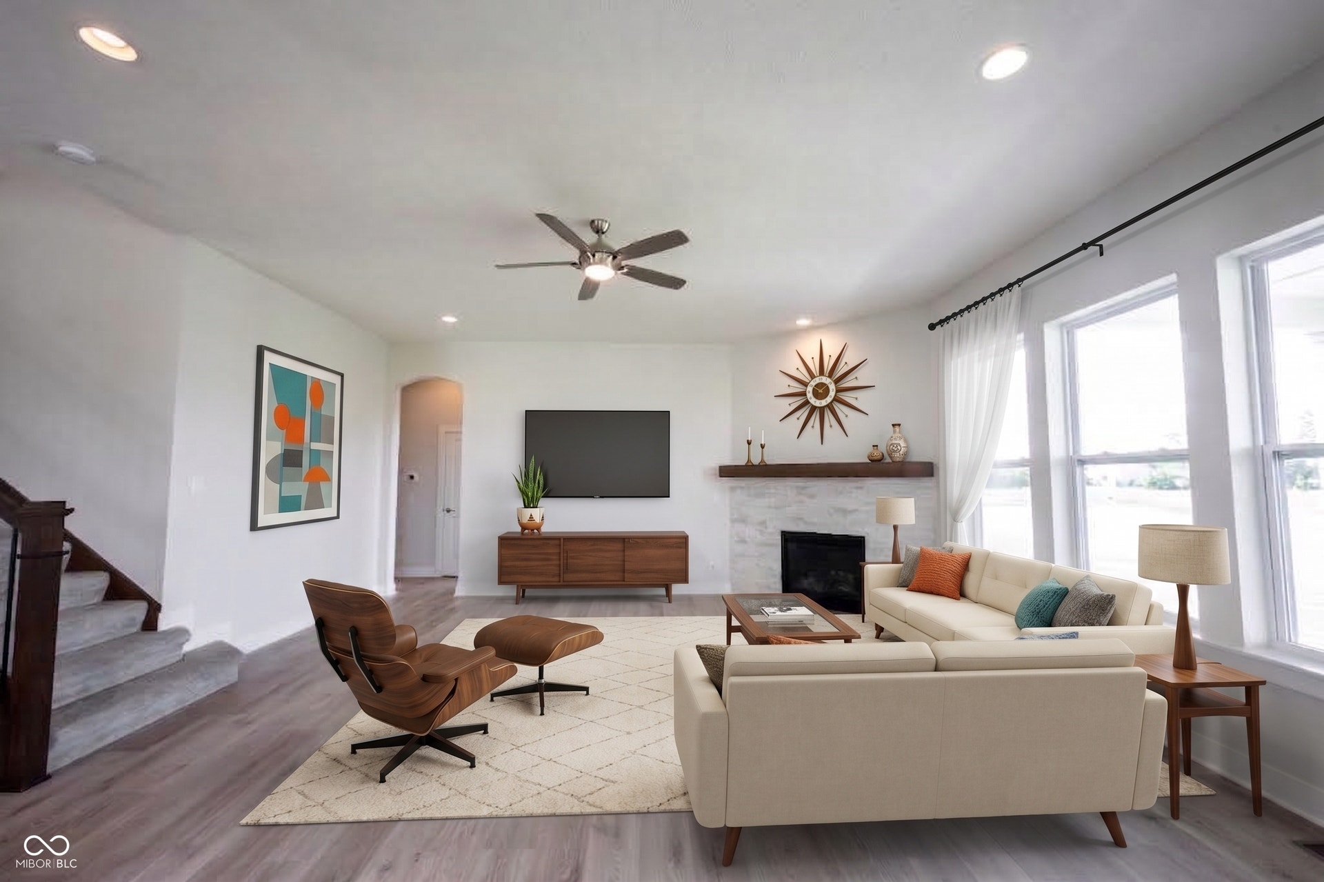 The main floor has 10ft ceilings  and this great room is spacious and full of natural light.  This photo is virtually staged.