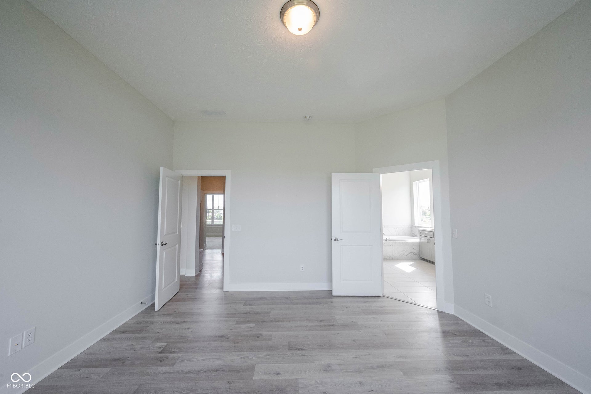 Another view/angle of the primary bedroom leading to the primary bath.