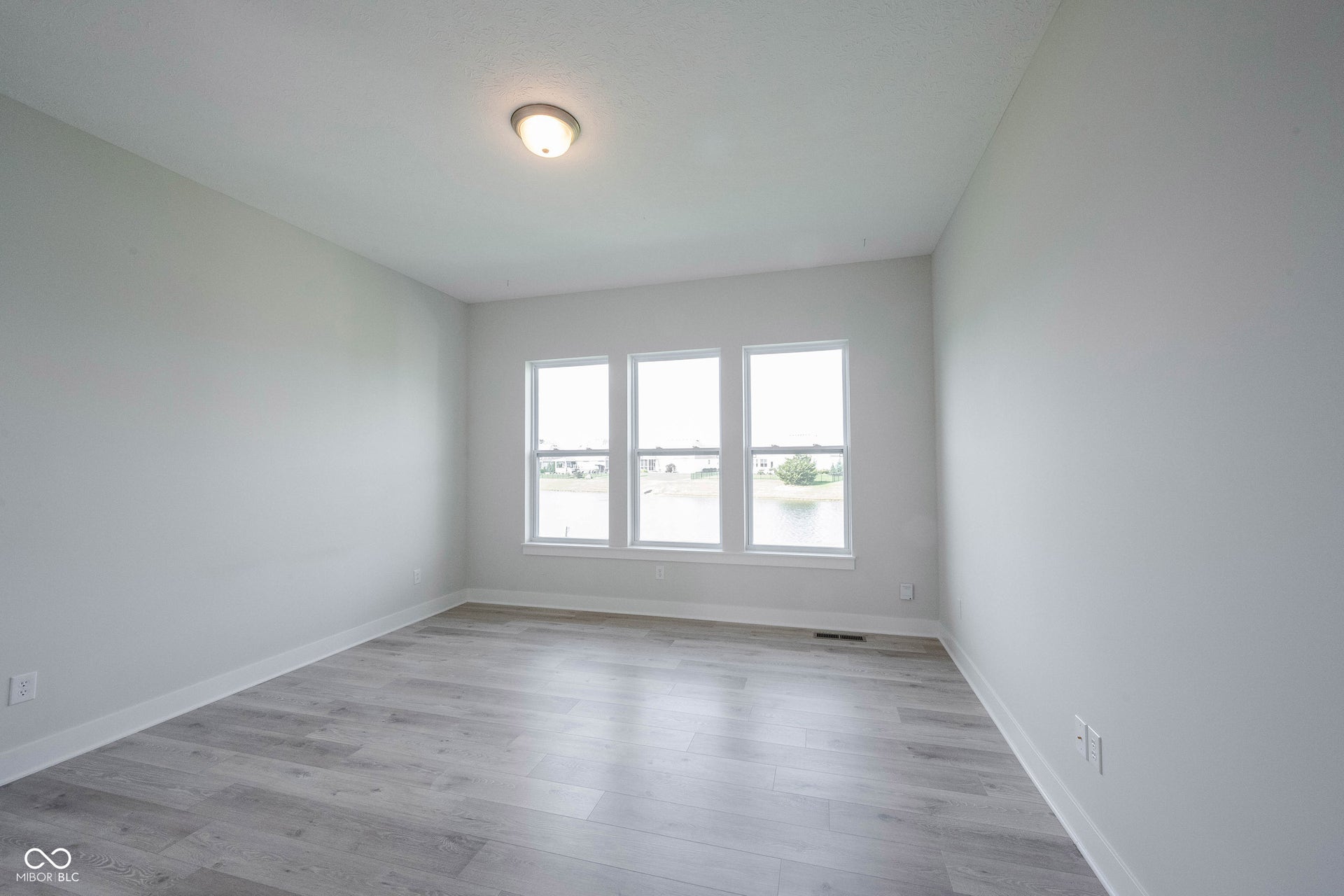 Same photo of the primary bedroom unstaged.