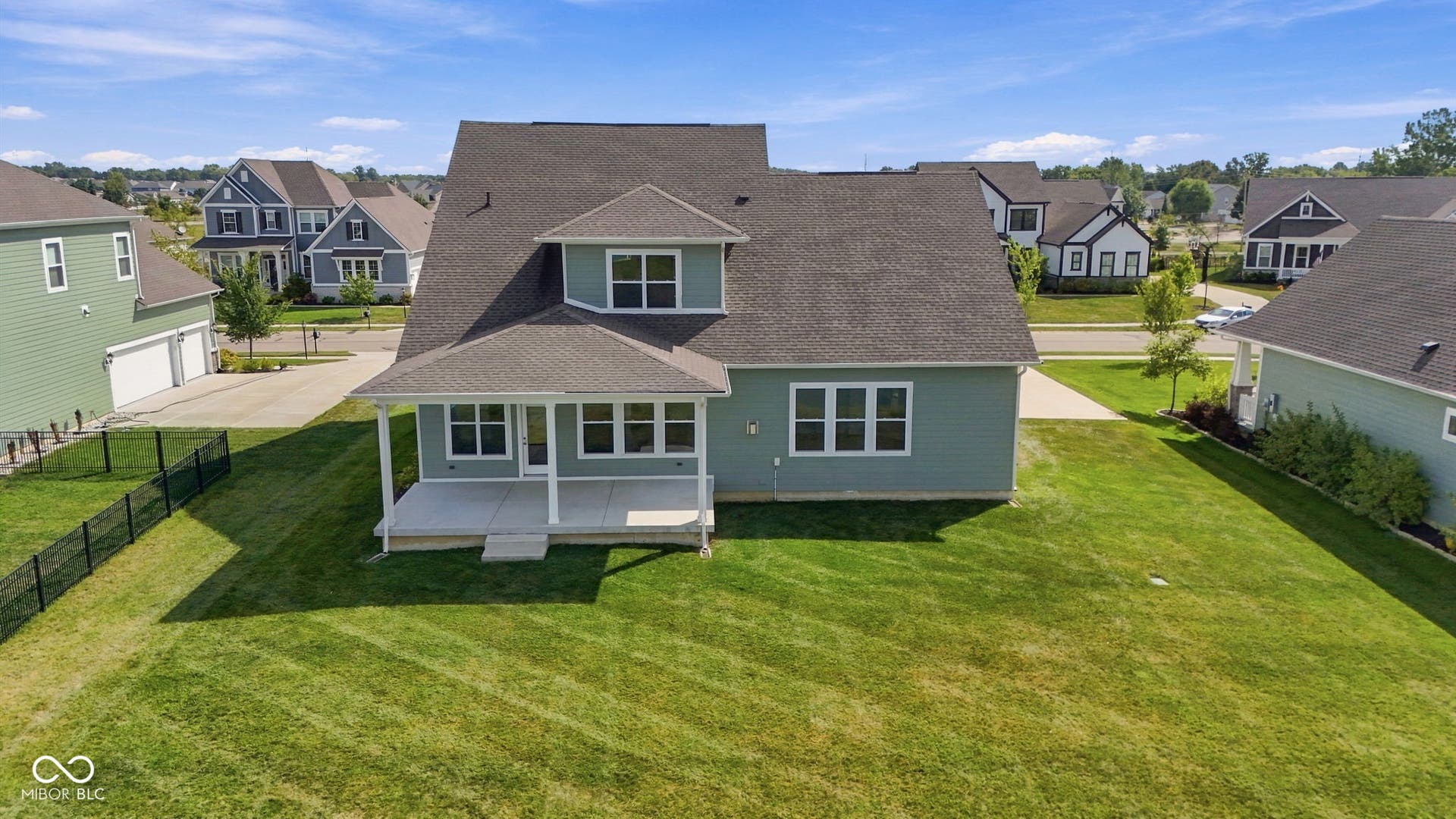 Drone shot of the back of the home and backyard