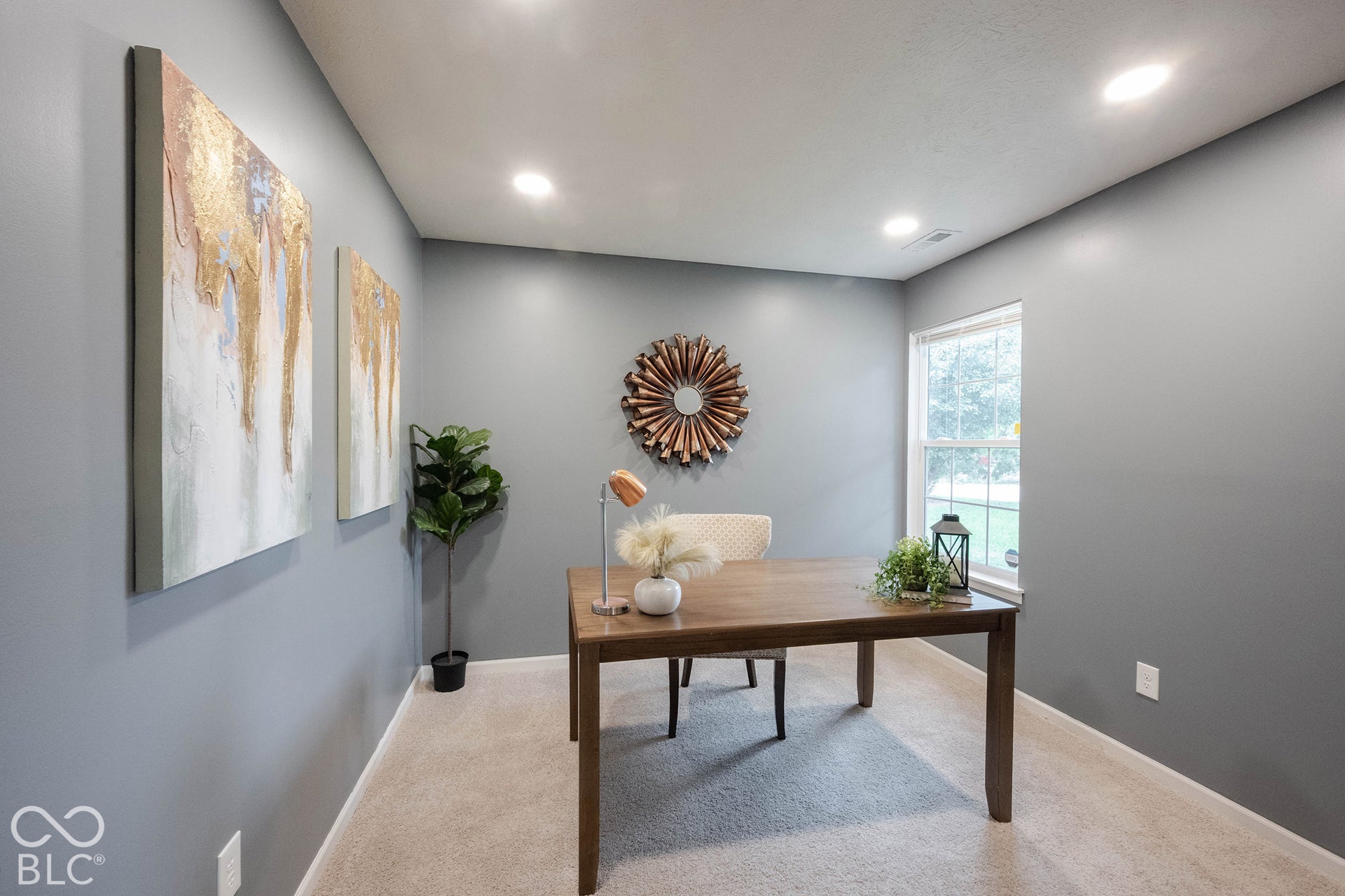 The office is conveniently situated just off the living room.