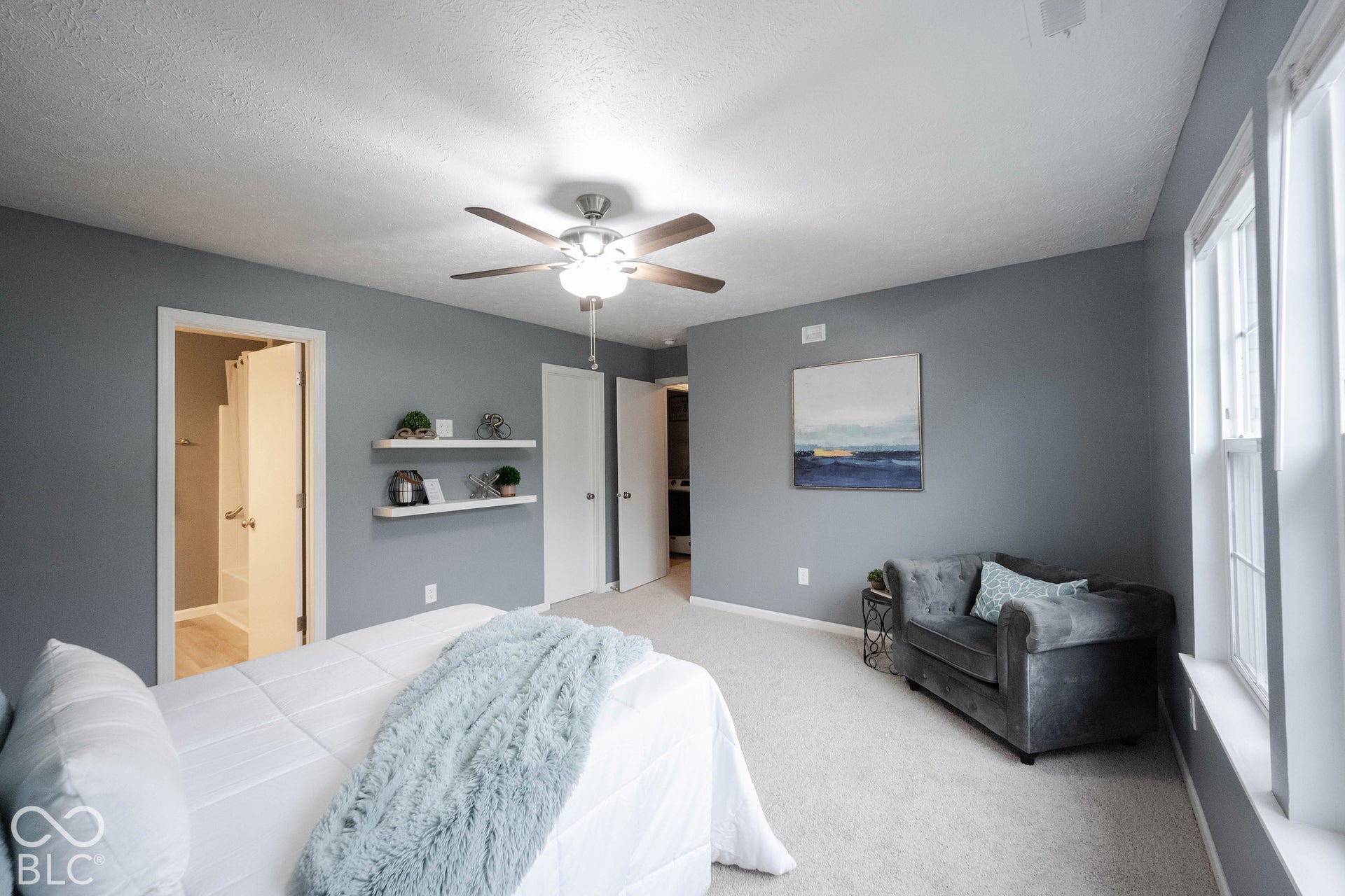 It showcases abundant natural light from large windows and built-in storage shelves!