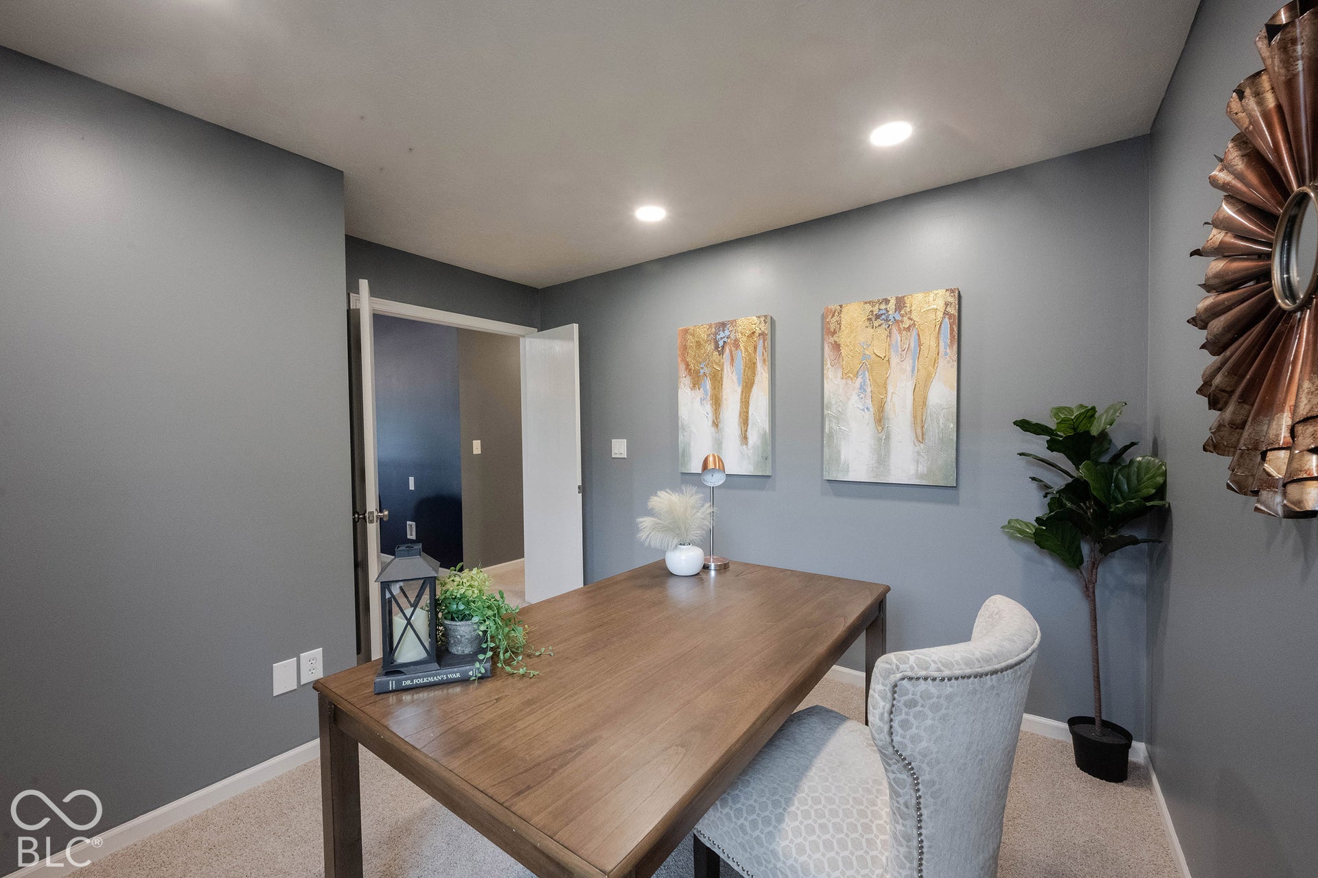 Neutral carpets, large windows, and classy double doors finish out this space!