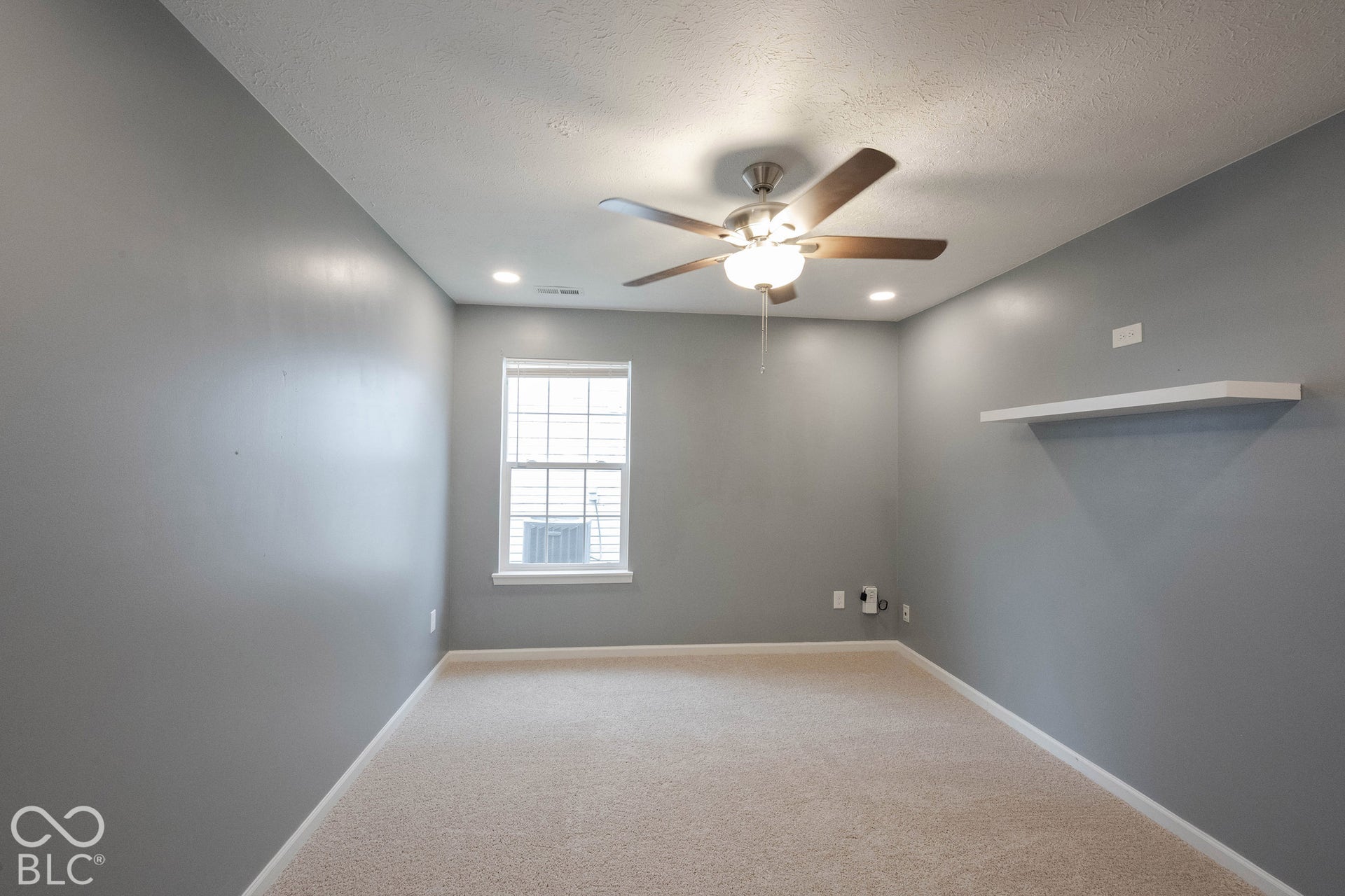 The third bedroom is adorable, with neutral walls and carpets.