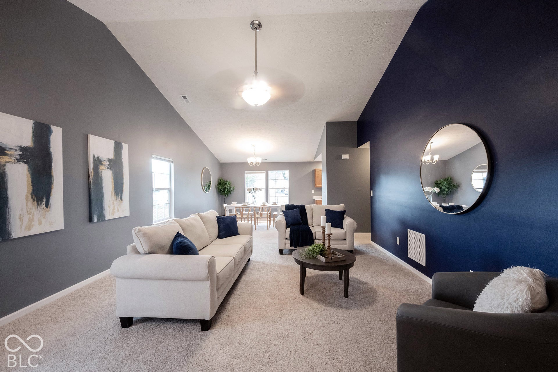 The open-concept living room features gorgeous vaulted ceilings!