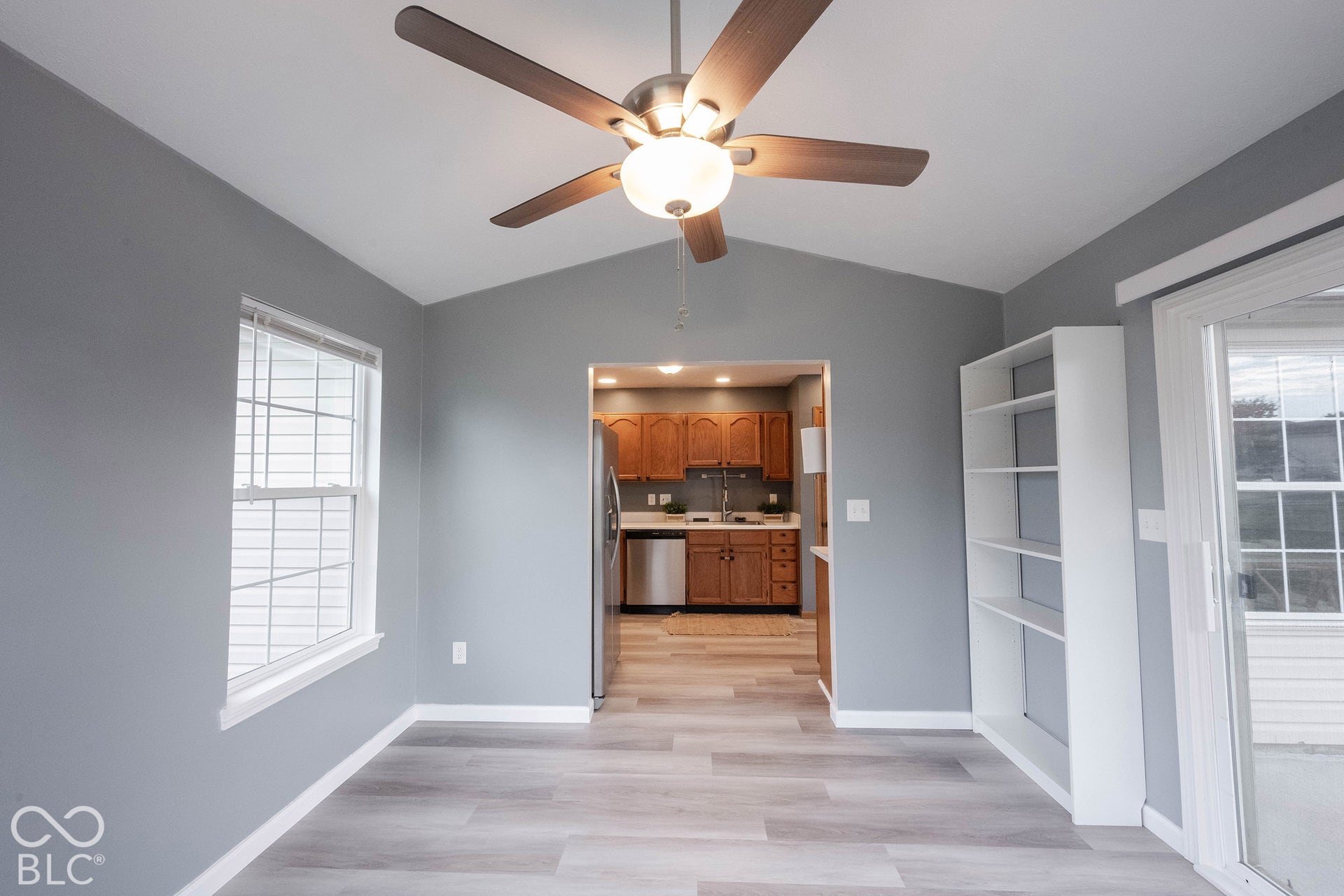The kitchen opens to a bright, open sun room with soaring ceilings and plenty of natural light!