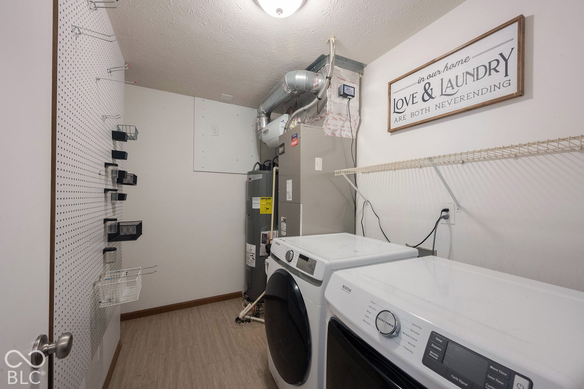 A large dedicated laundry room features abundant storage shelving with lots of space to work!  Plus washer/dryer stay!
