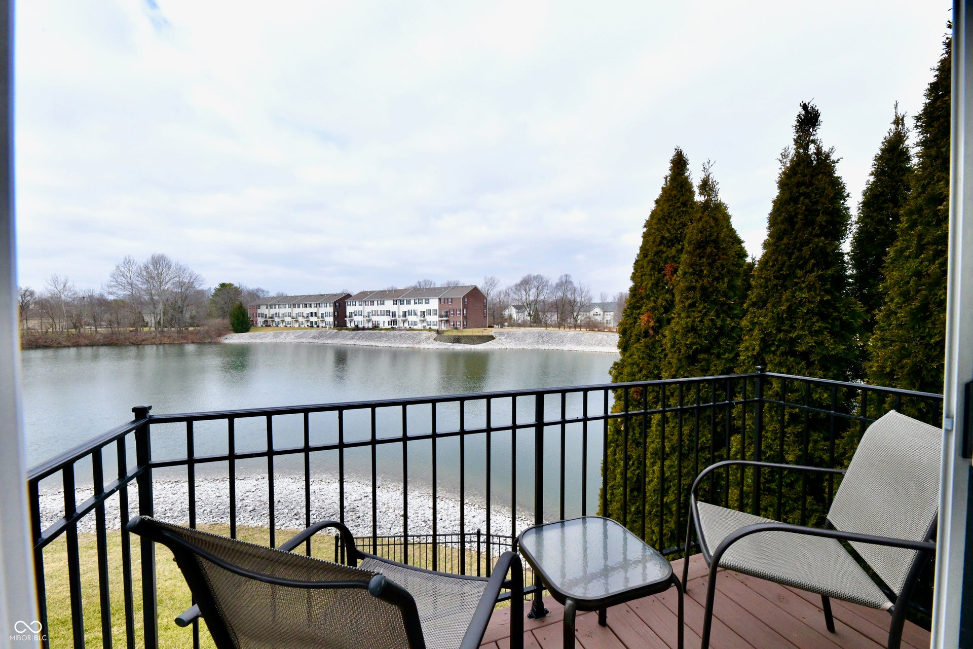 Private balcony with dark wood decking and black metal railing