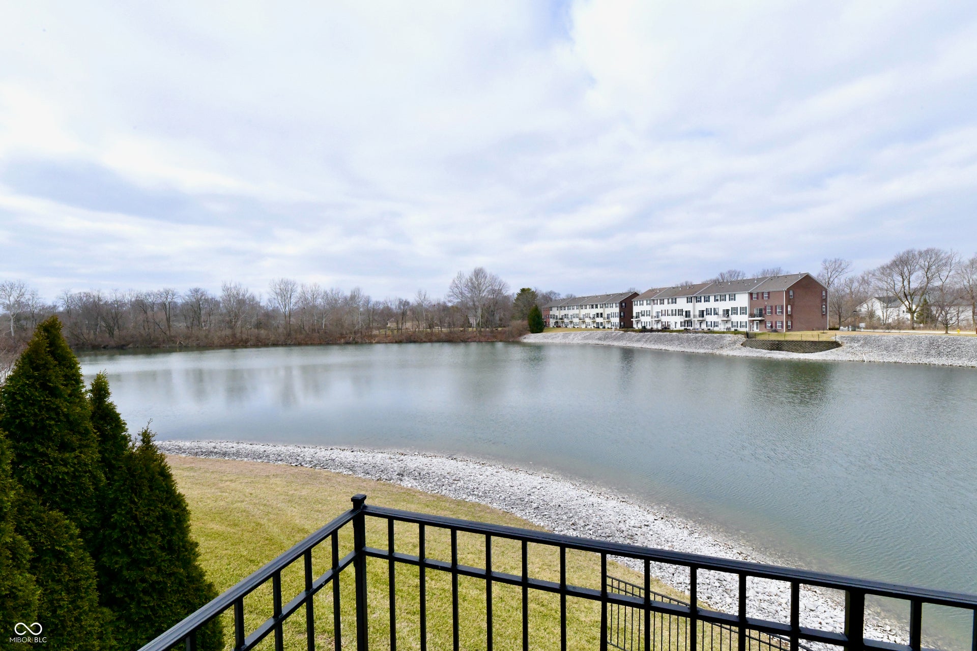 Expansive waterfront with a gravel bank and surrounding trees
