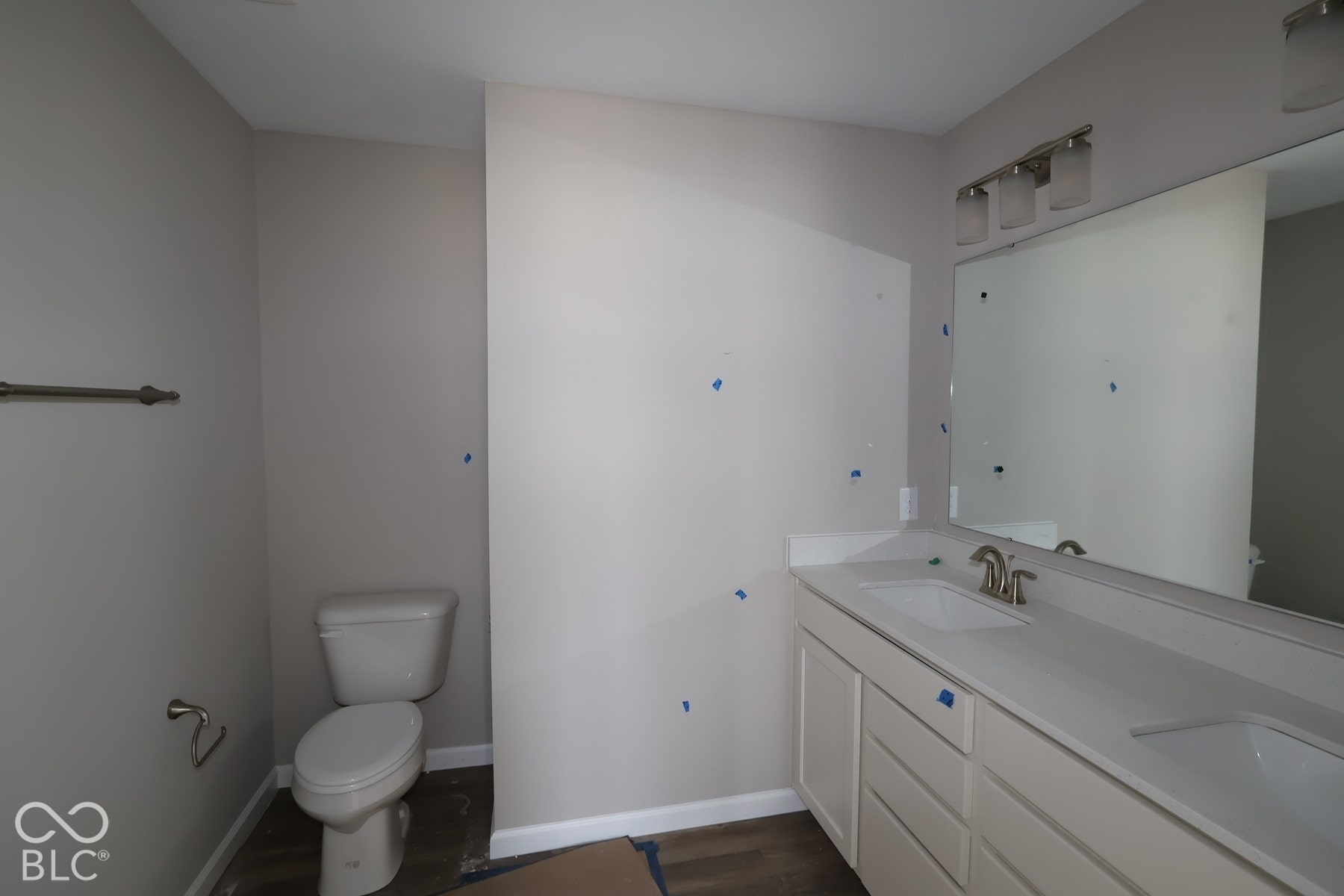 Double vanity with integrated sinks, brushed nickel fixtures, and a large mirror