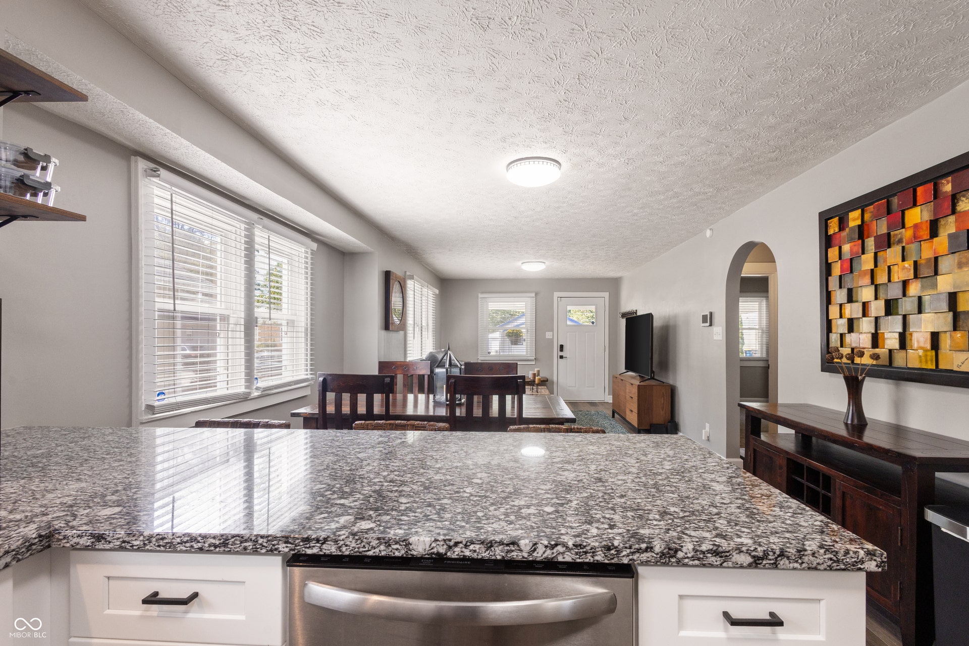 4927 Caroline Avenue, Indianapolis, IN 46205 Granite-finish countertops, white shaker cabinetry with black hardware, and an integrated stainless steel appliance