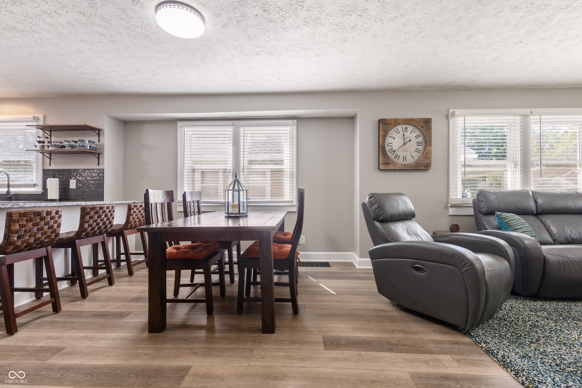 4927 Caroline Avenue, Indianapolis, IN 46205 Wood-finish vinyl flooring, updated lighting (and electrical work throughout), double windows, kitchen island with built-in bar seating, and open shelving
