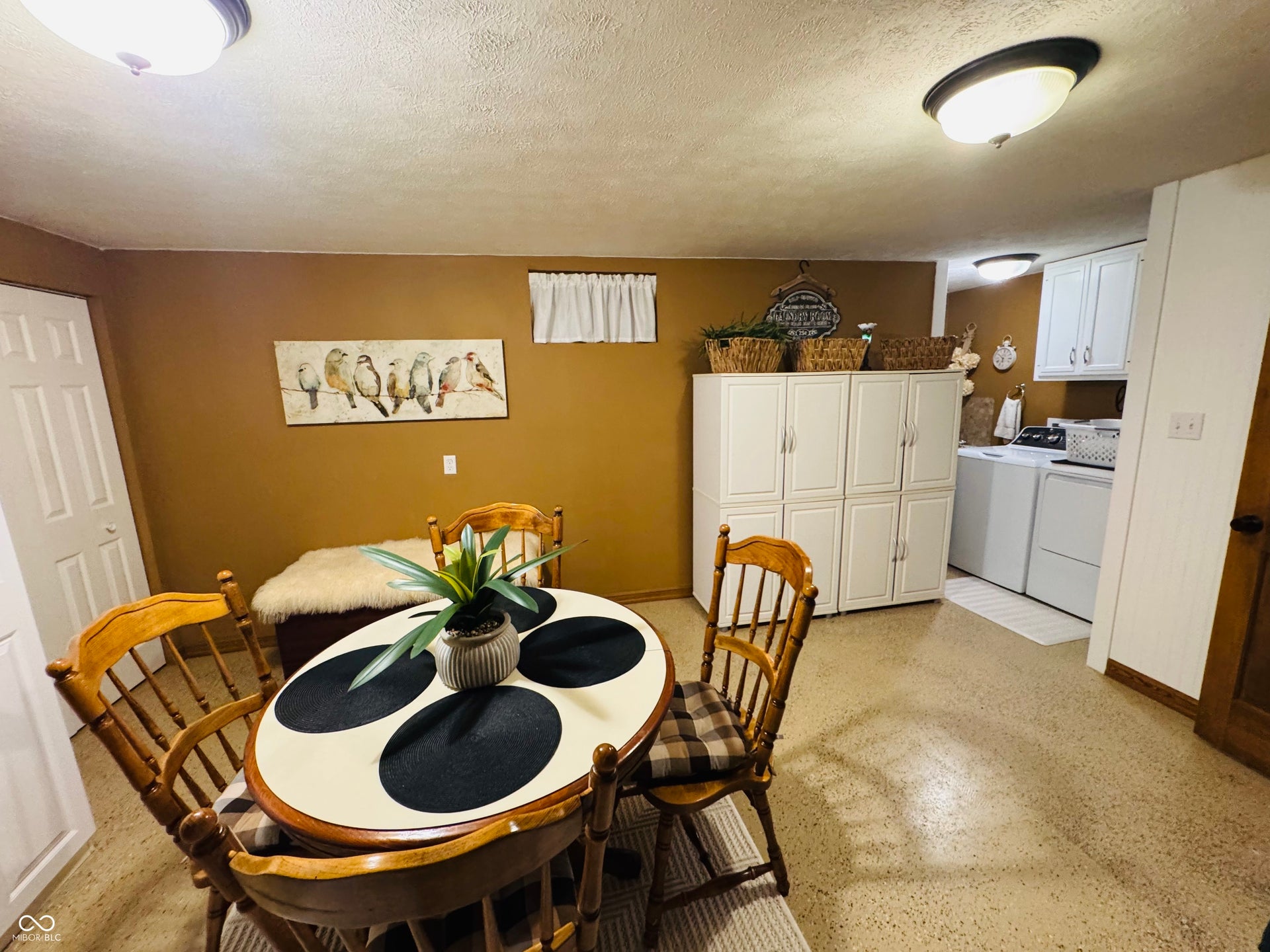 Built-in white cabinetry, light-toned flooring, flush-mount ceiling lights, and painted walls