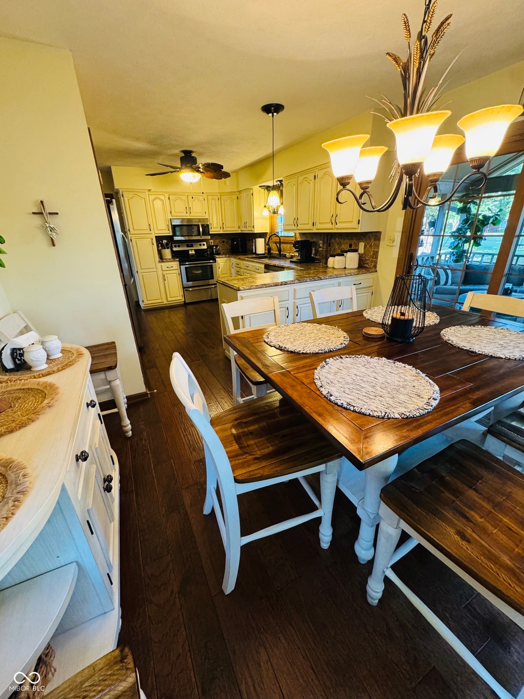 Kitchen featuring cream-colored cabinetry, stainless steel appliances, and granite countertops