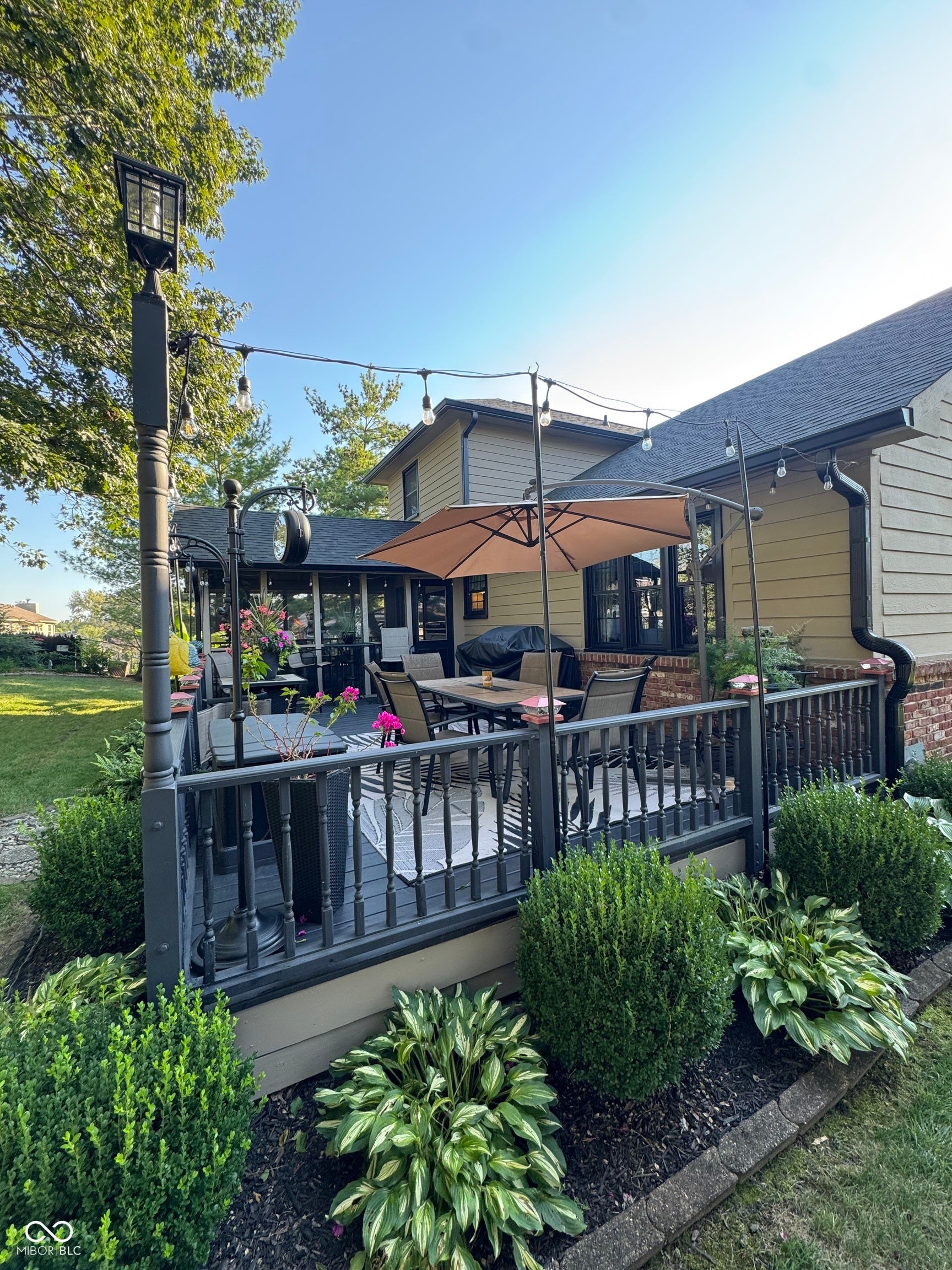 Expansive outdoor deck featuring dark-stained wood flooring and balusters