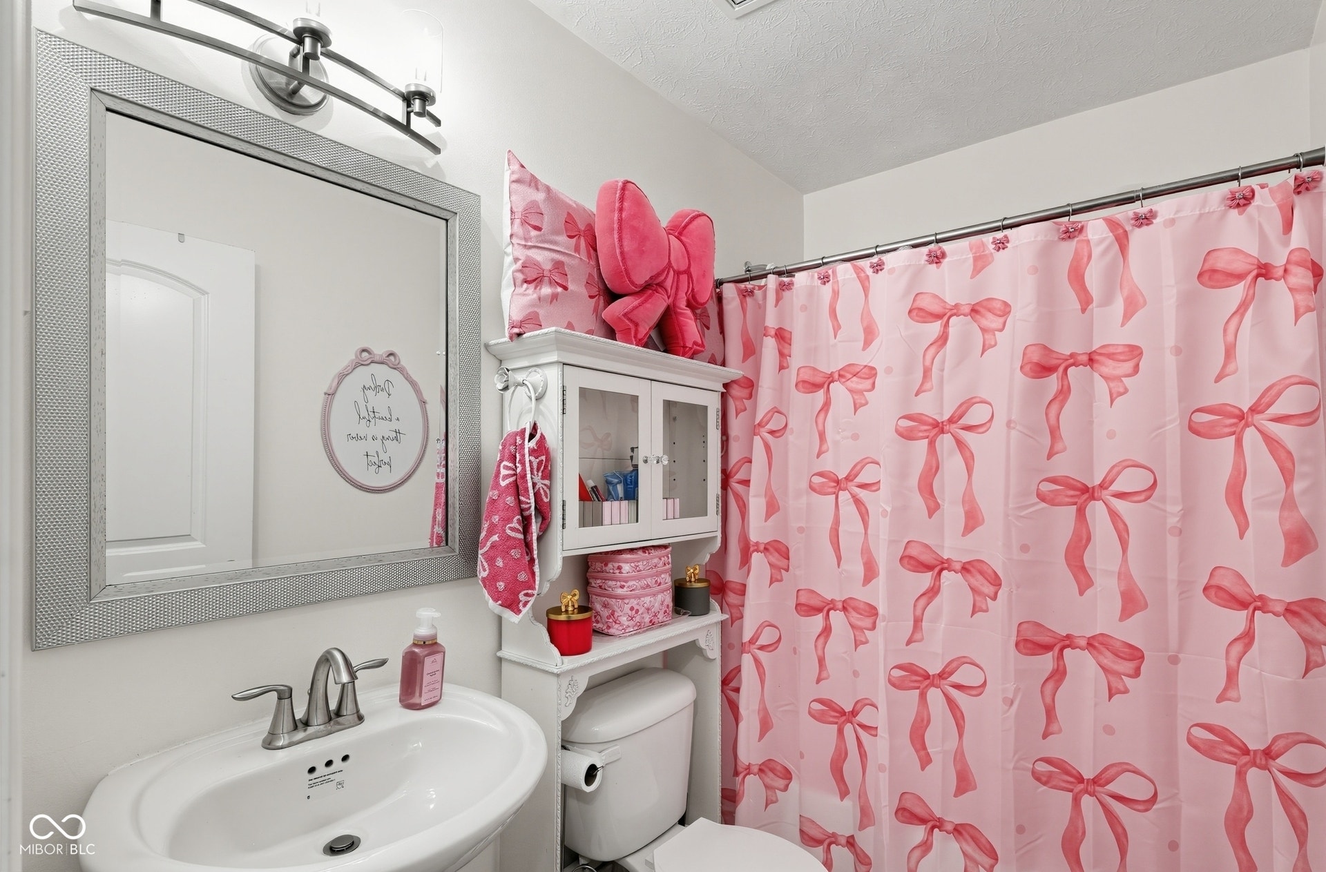 3394 S Bennett Drive, New Palestine, IN 46163 Full second floor bath with Pedestal,brushed nickel faucet, framed mirror with integrated lighting, and a white built-in storage cabinet