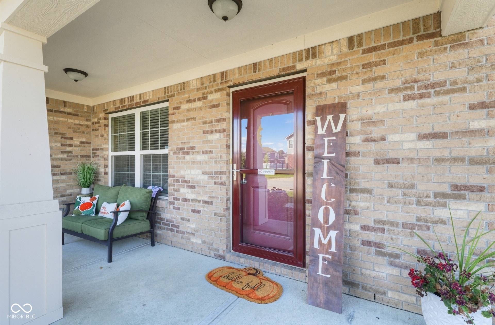 3394 S Bennett Drive, New Palestine, IN 46163 Brick exterior with a covered porch, white columns, and an entry door with glass paneling