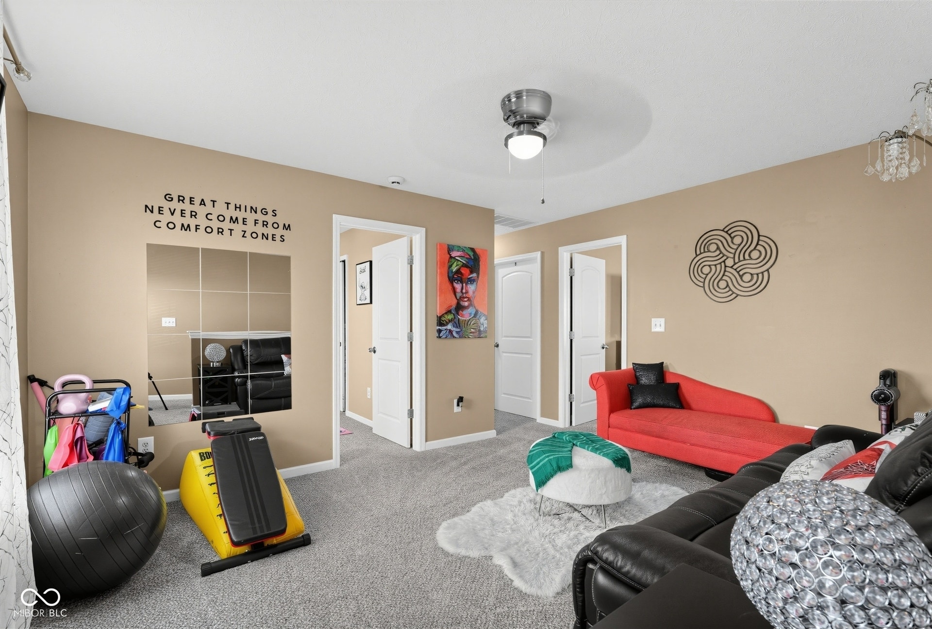 3394 S Bennett Drive, New Palestine, IN 46163 Ceiling fan with light fixture, recessed ceiling detail, light-colored walls, multiple doorways, and gray carpeted flooring