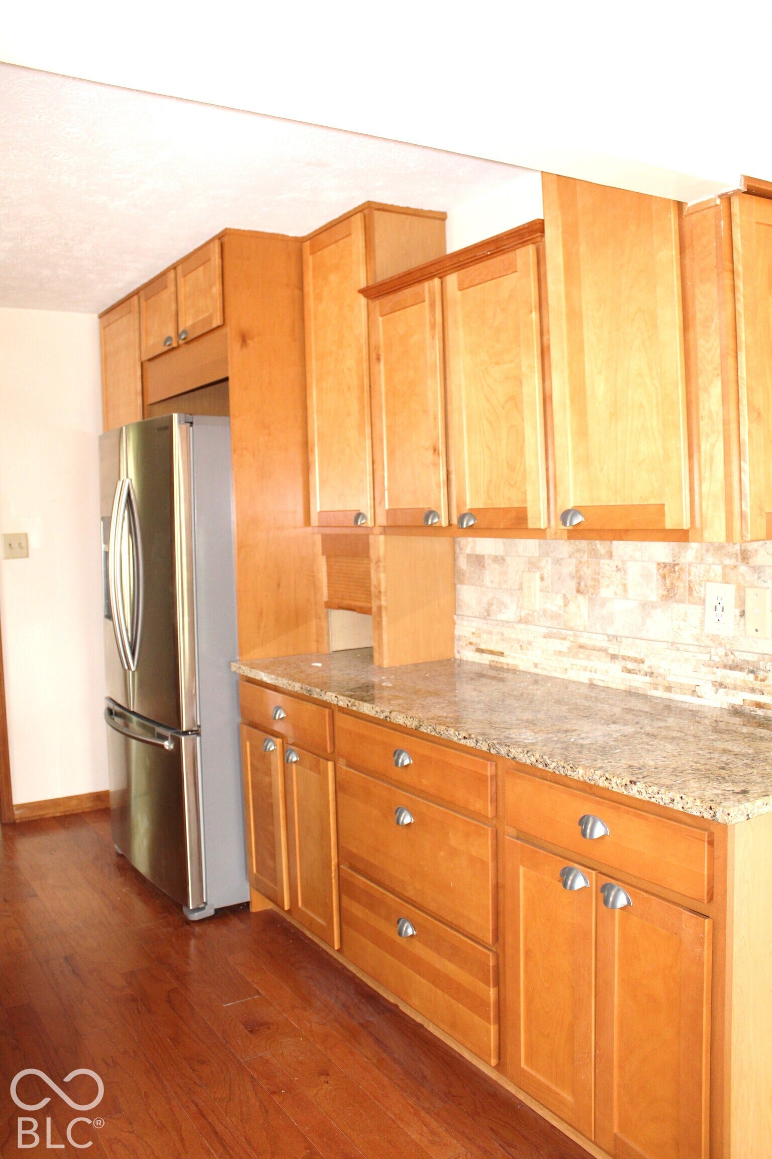 Kitchen with Abundant Cabinetry and Wood Flooring