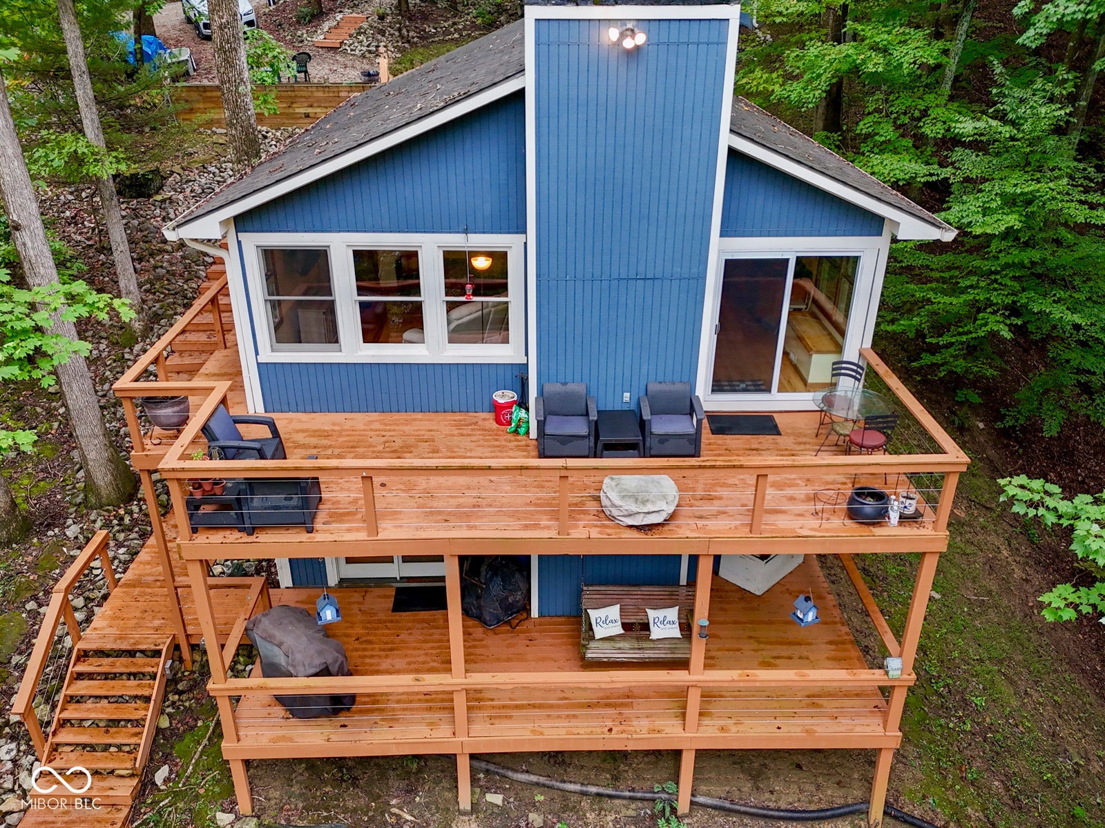 Multi-level wood-finish decking with metal cable railings