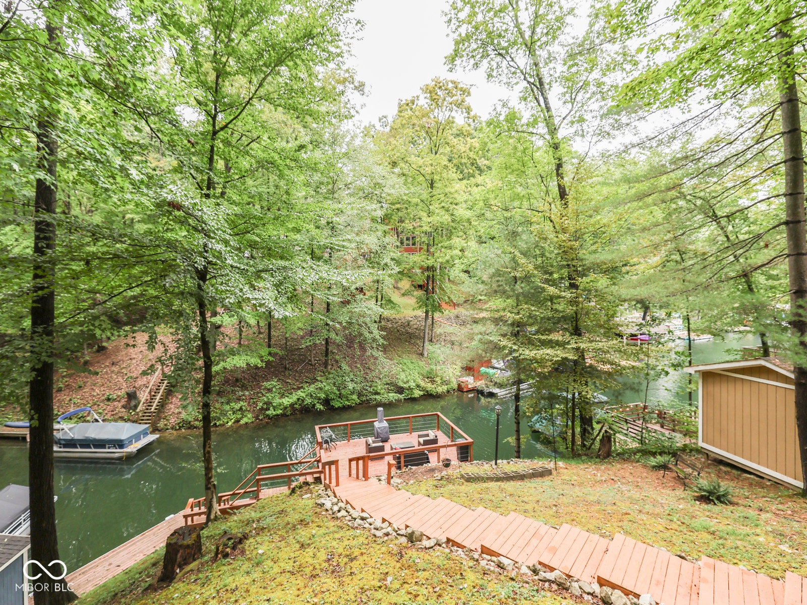 Private dock with built-in seating, direct water access, and exterior storage shed
