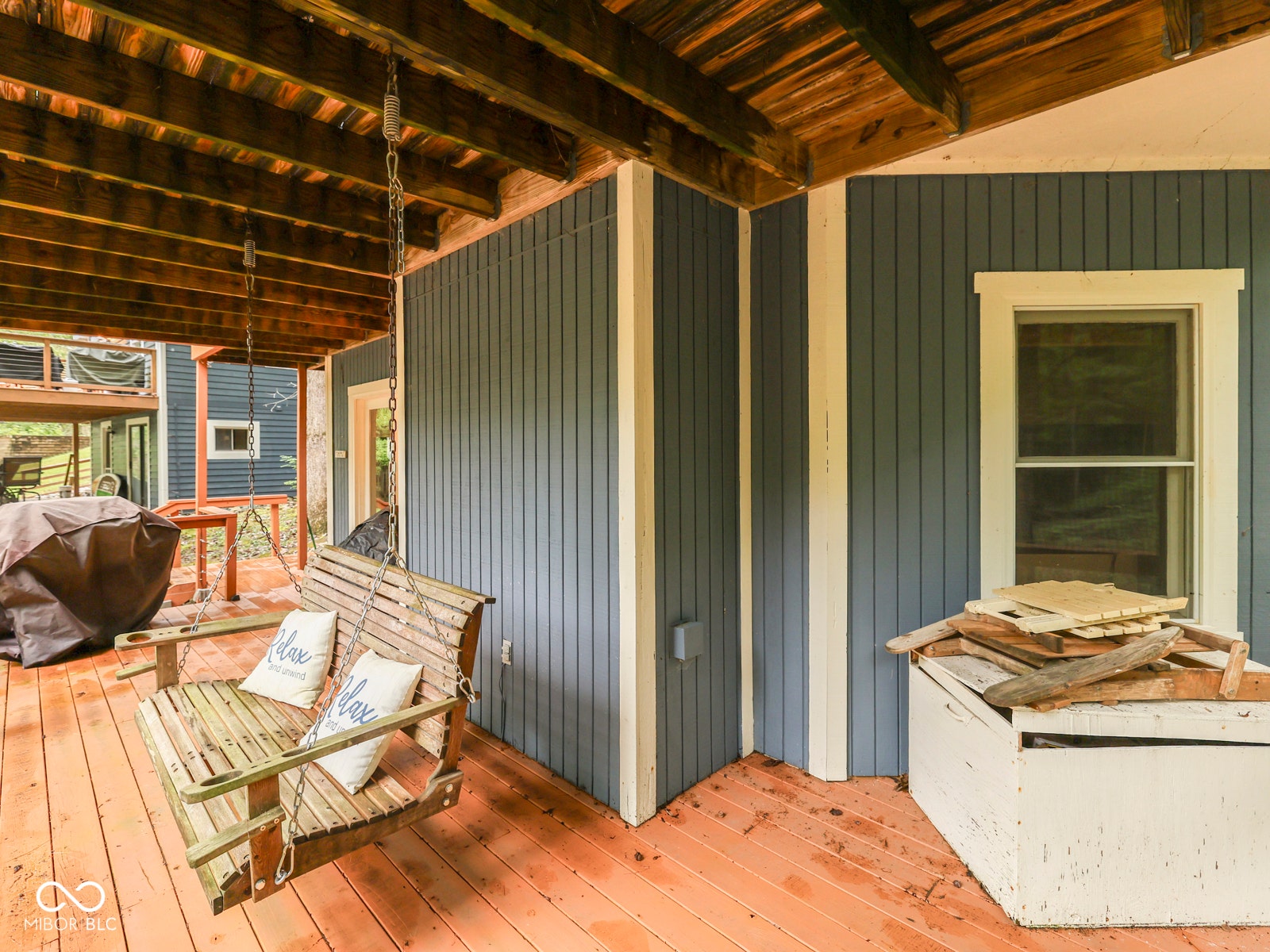 Wood-finish deck with exposed wood beam ceiling