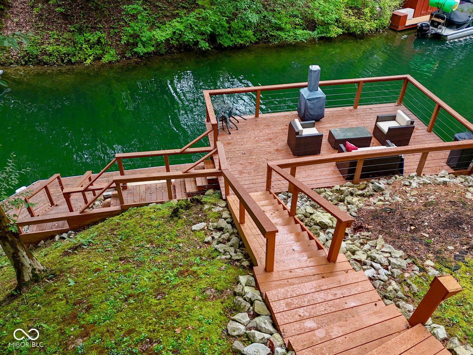 Multi-level wood-finish decking with cable railings and integrated stairs