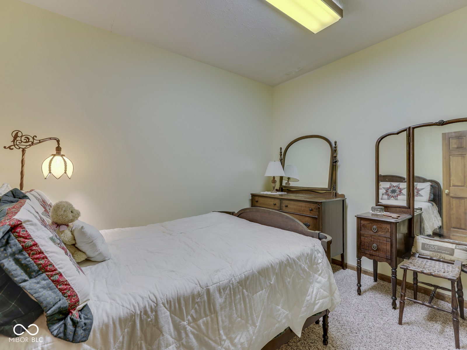 Neutral wall paint, textured ceiling, and carpeted flooring