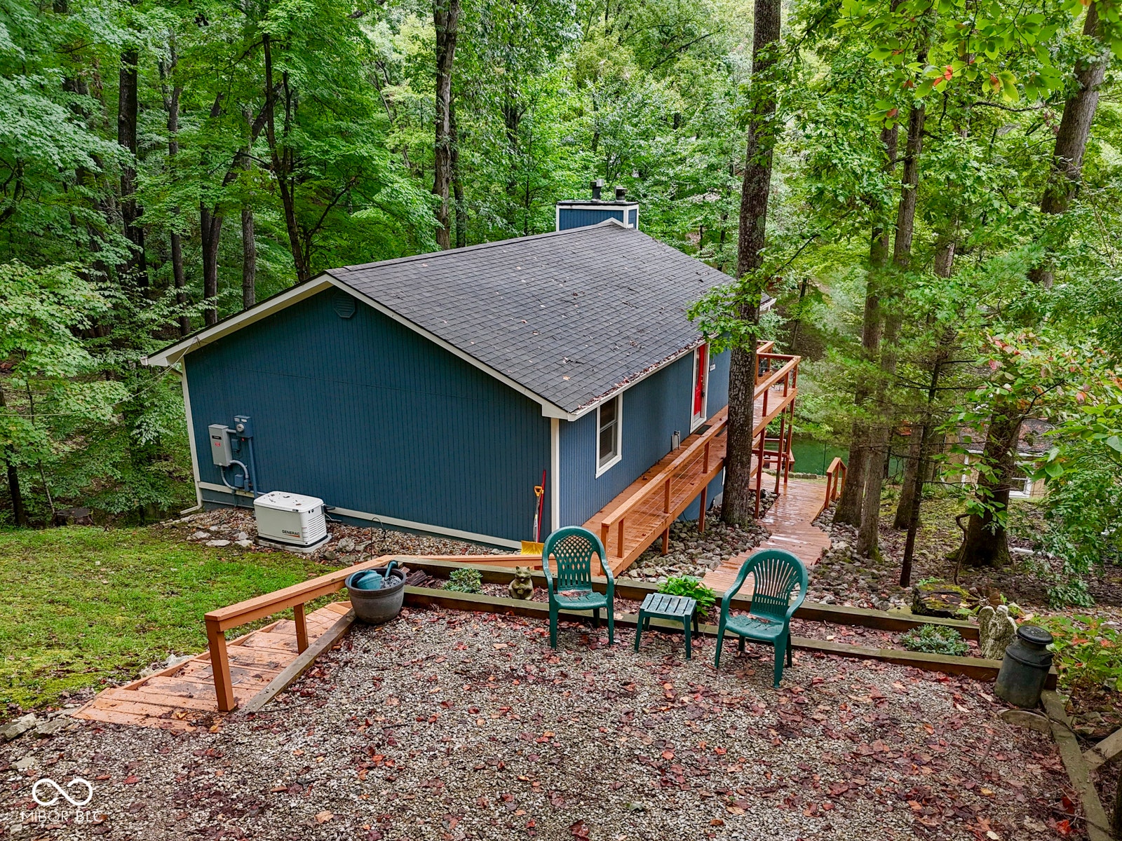 Blue siding exterior with a dark shingle roof