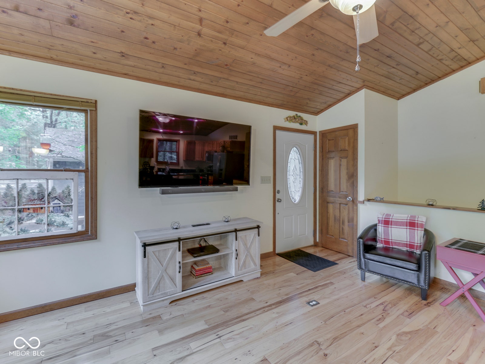 Wood-finish plank flooring and a wood plank ceiling