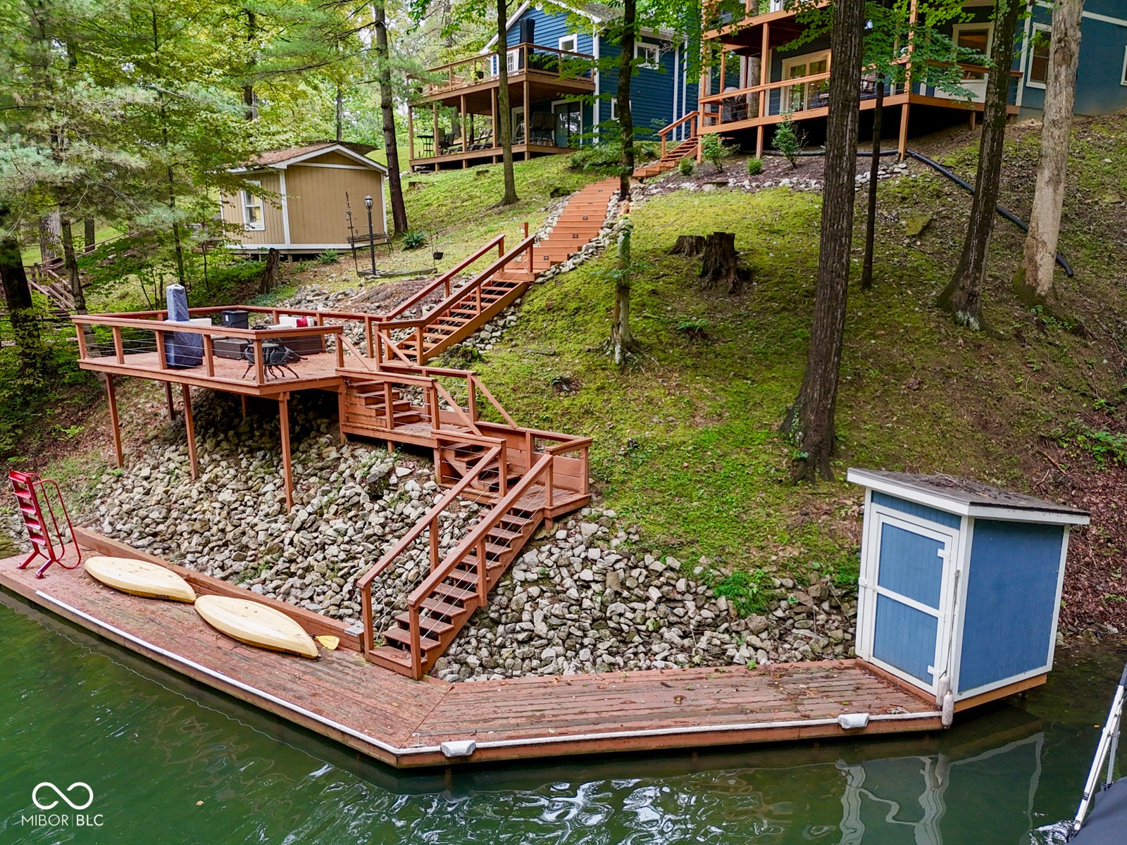 Expansive wood deck with railings, connected by multiple levels of wood stairs