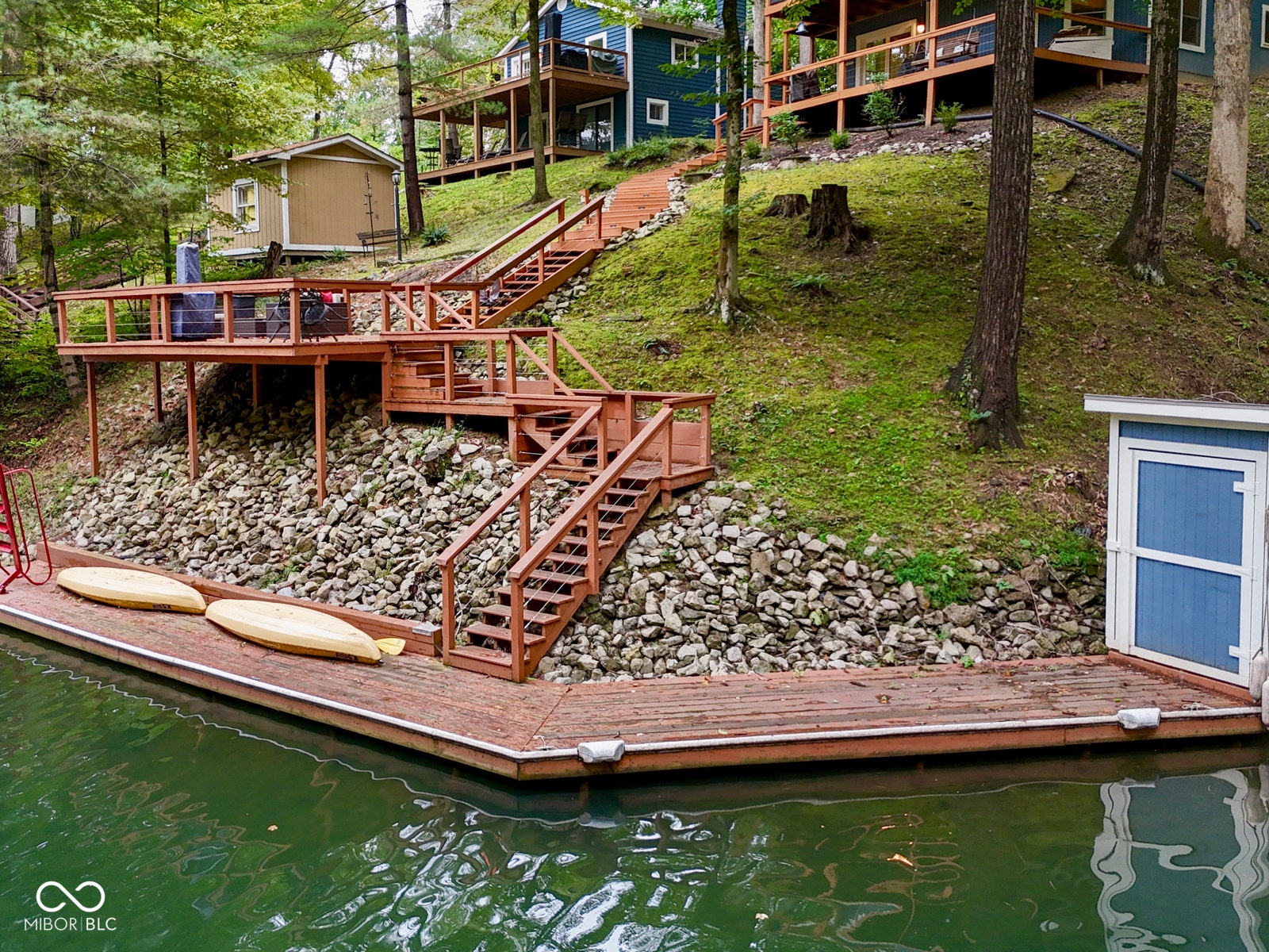 Wood-plank dock with a built-in storage shed