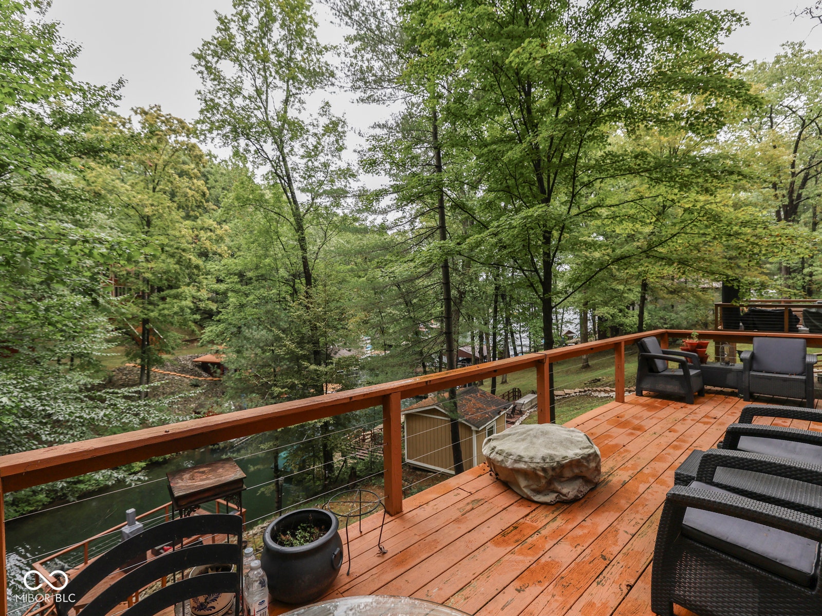Expansive wood deck with cable railing, offering substantial outdoor living space