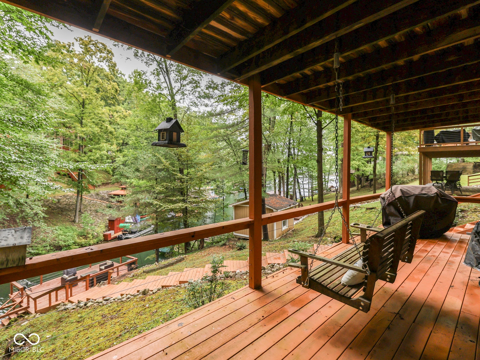 Expansive wooden deck with an overhead structure and a durable railing system